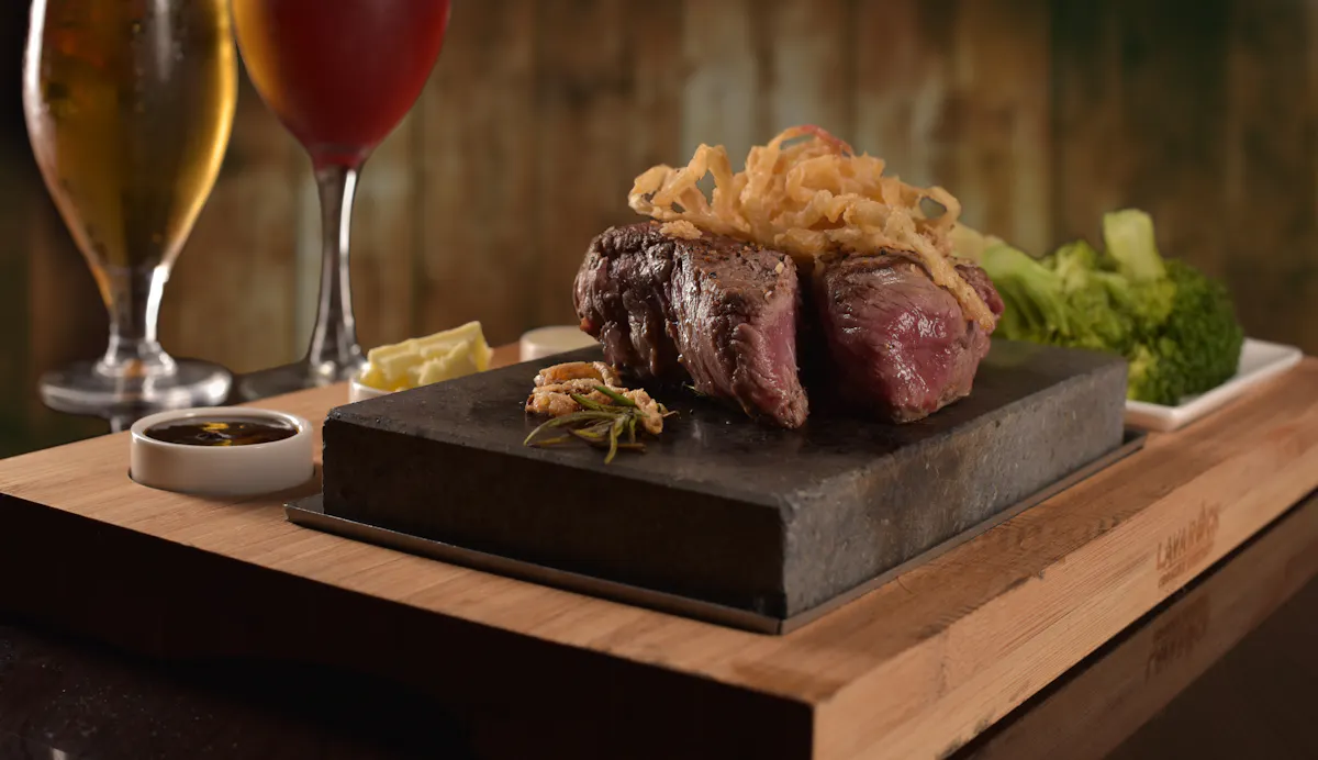 a glass of wine sitting on top of a table full of food