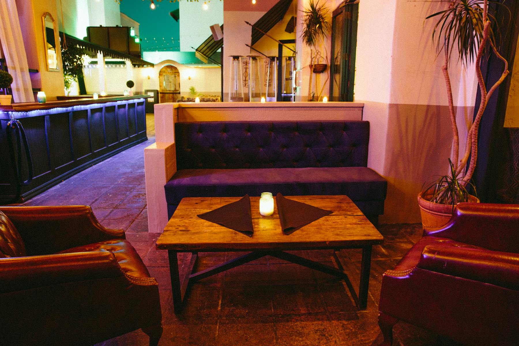 a small table in front of a purple couch