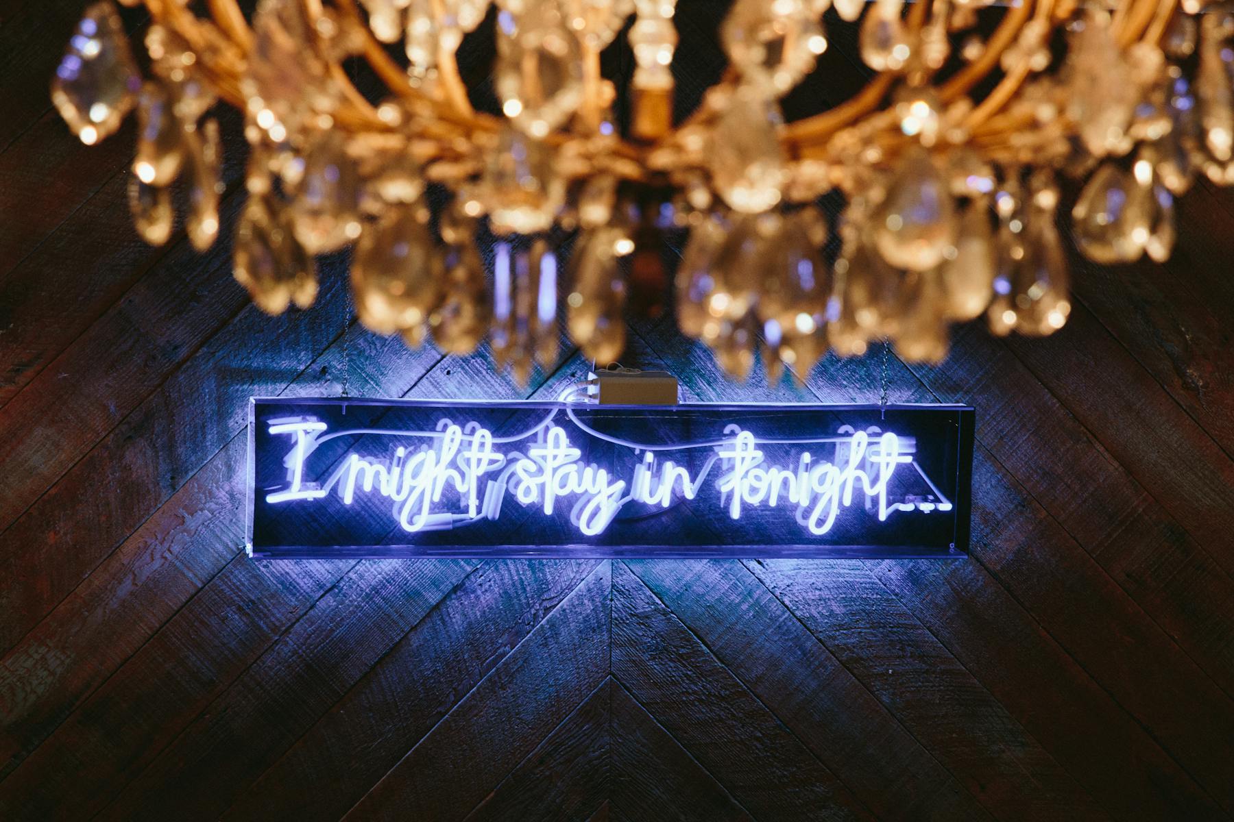 a neon sign placed on a wooden wall