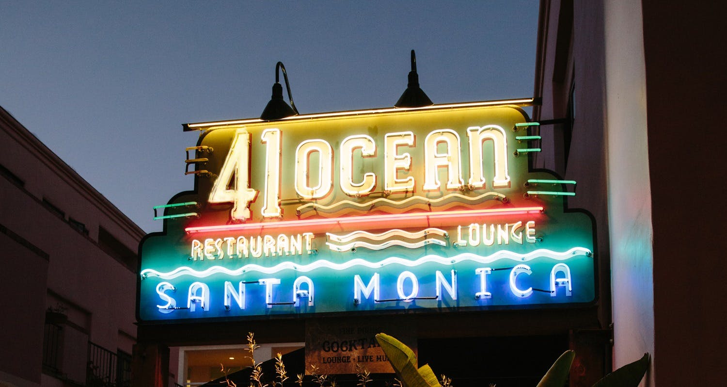 a sign above a bar entrance