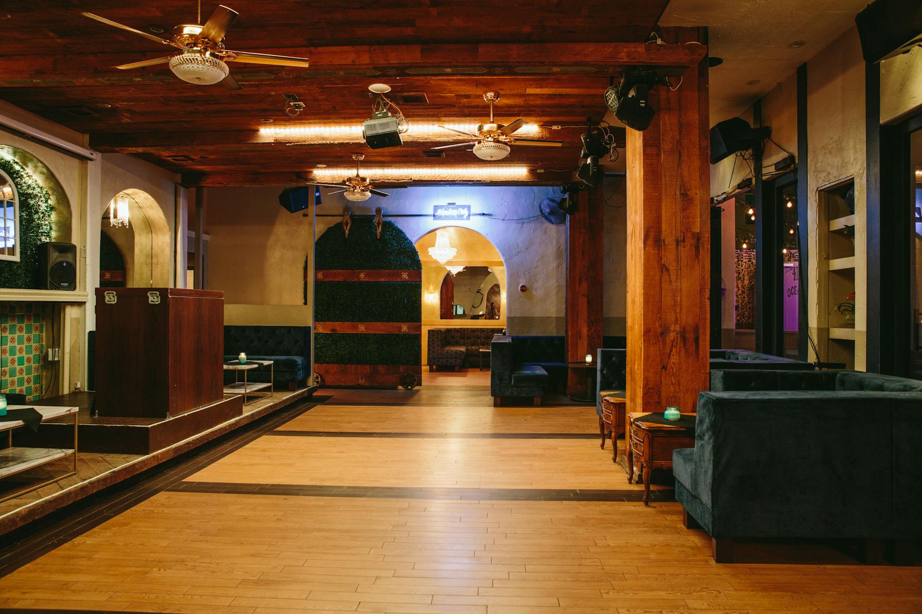 a large room filled with a shelf and ceiling fans