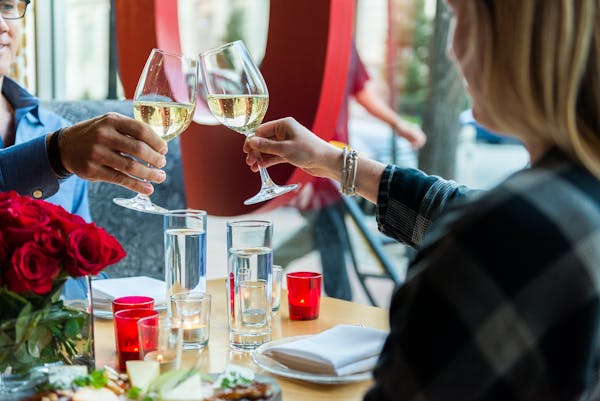 a person drinking a glass of wine