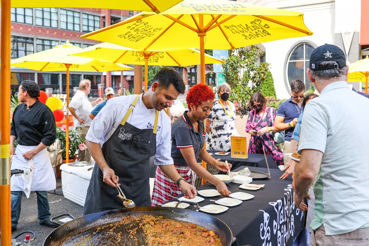 a group of people standing around a table