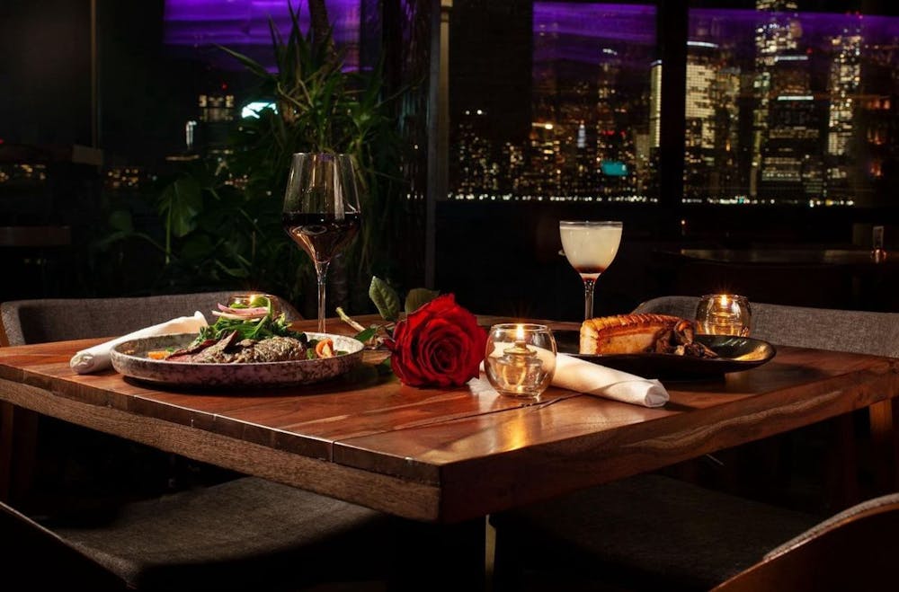 a glass of wine sitting on top of a wooden table