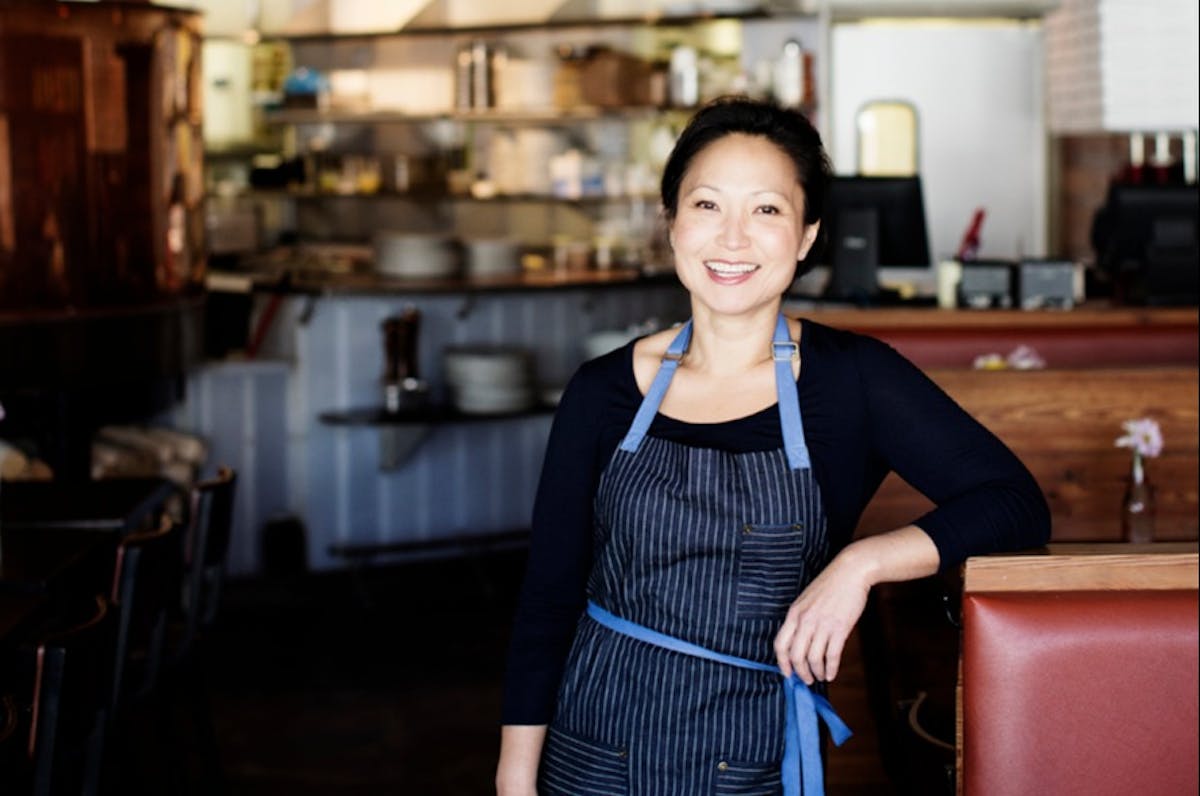 a woman standing in front of a restaurant