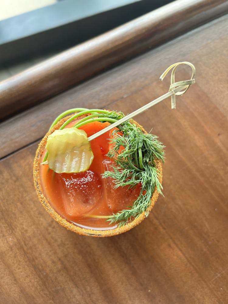 a bowl of food sitting on top of a wooden table