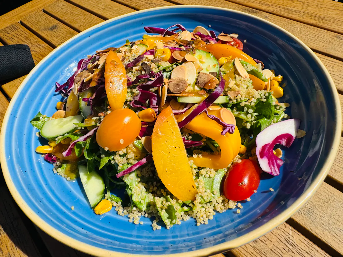 a blue plate with a salad on it