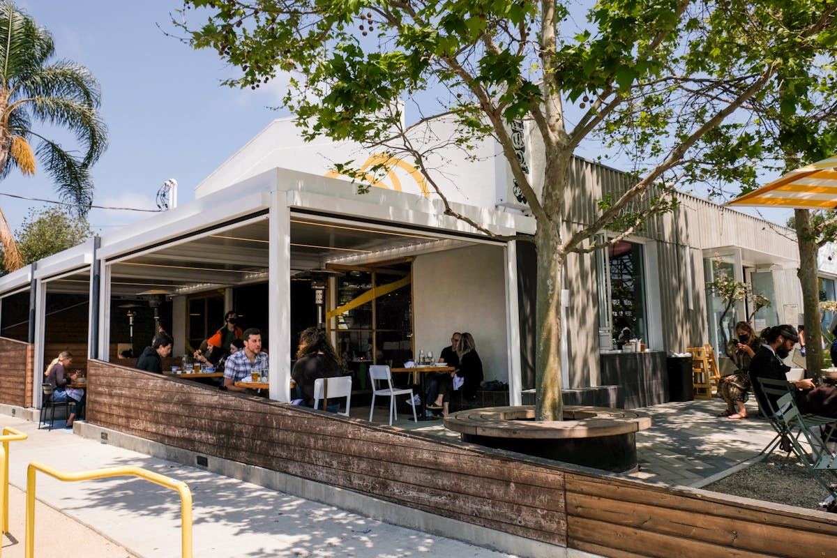 a group of people dining in front of a building