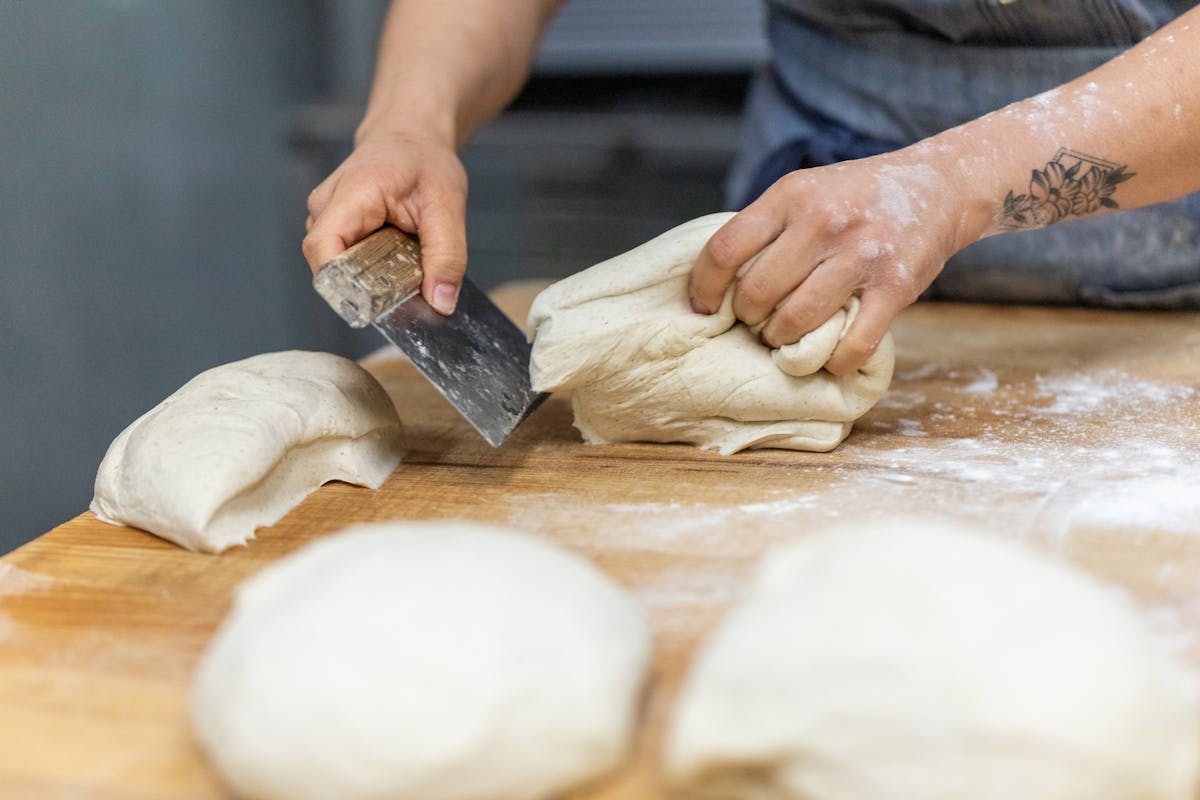 a close up of a cutting board with dough