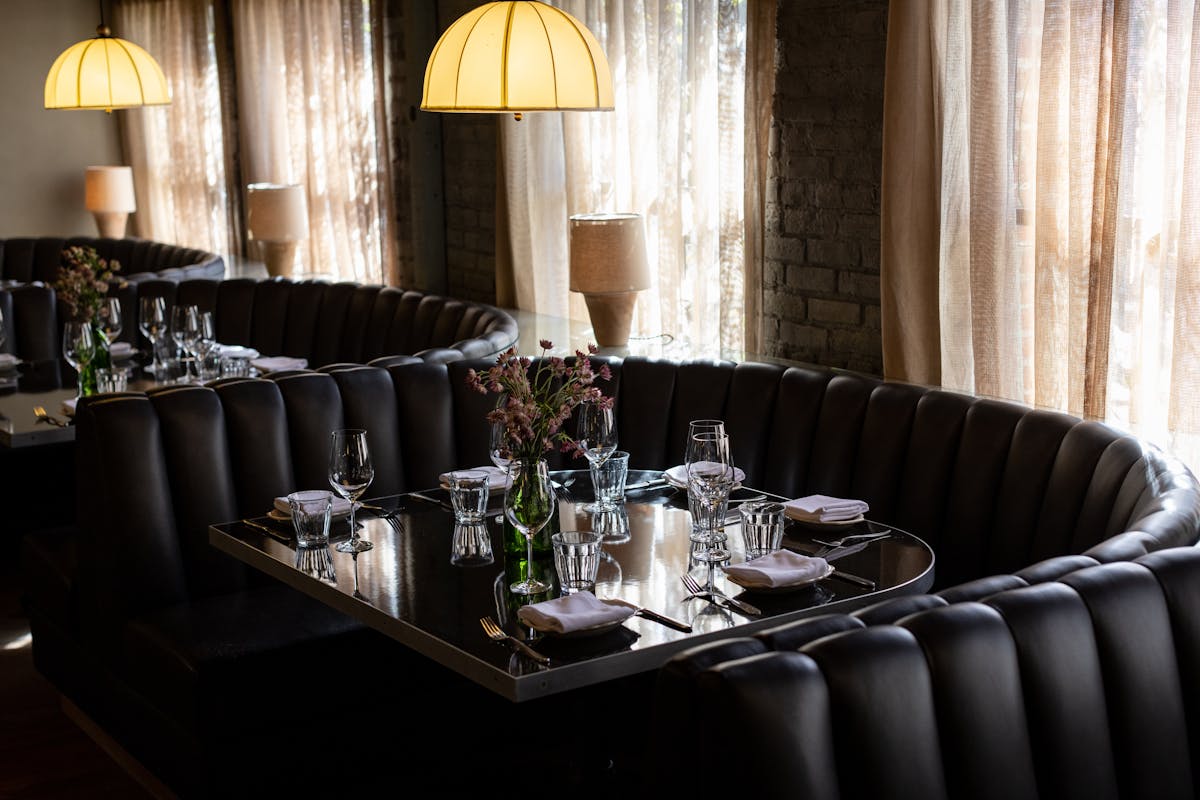 a dining room table in front of a curtain