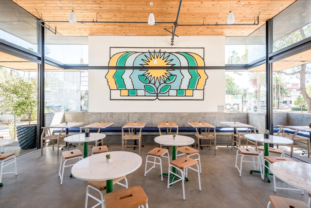 a room filled with furniture and a table in front of a building