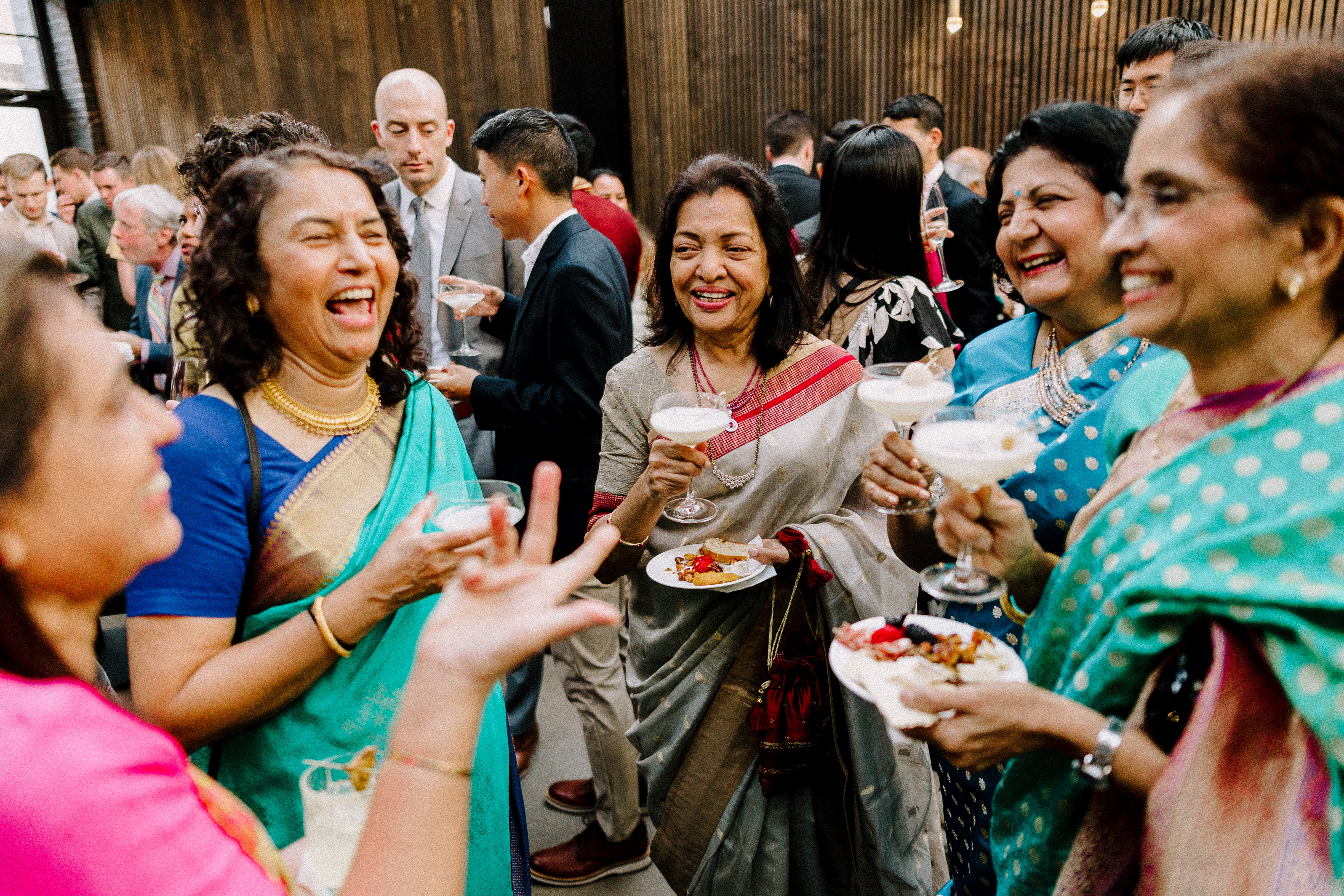A group of women eating, drinking, and enjoying a cocktail hour at a winery wedding