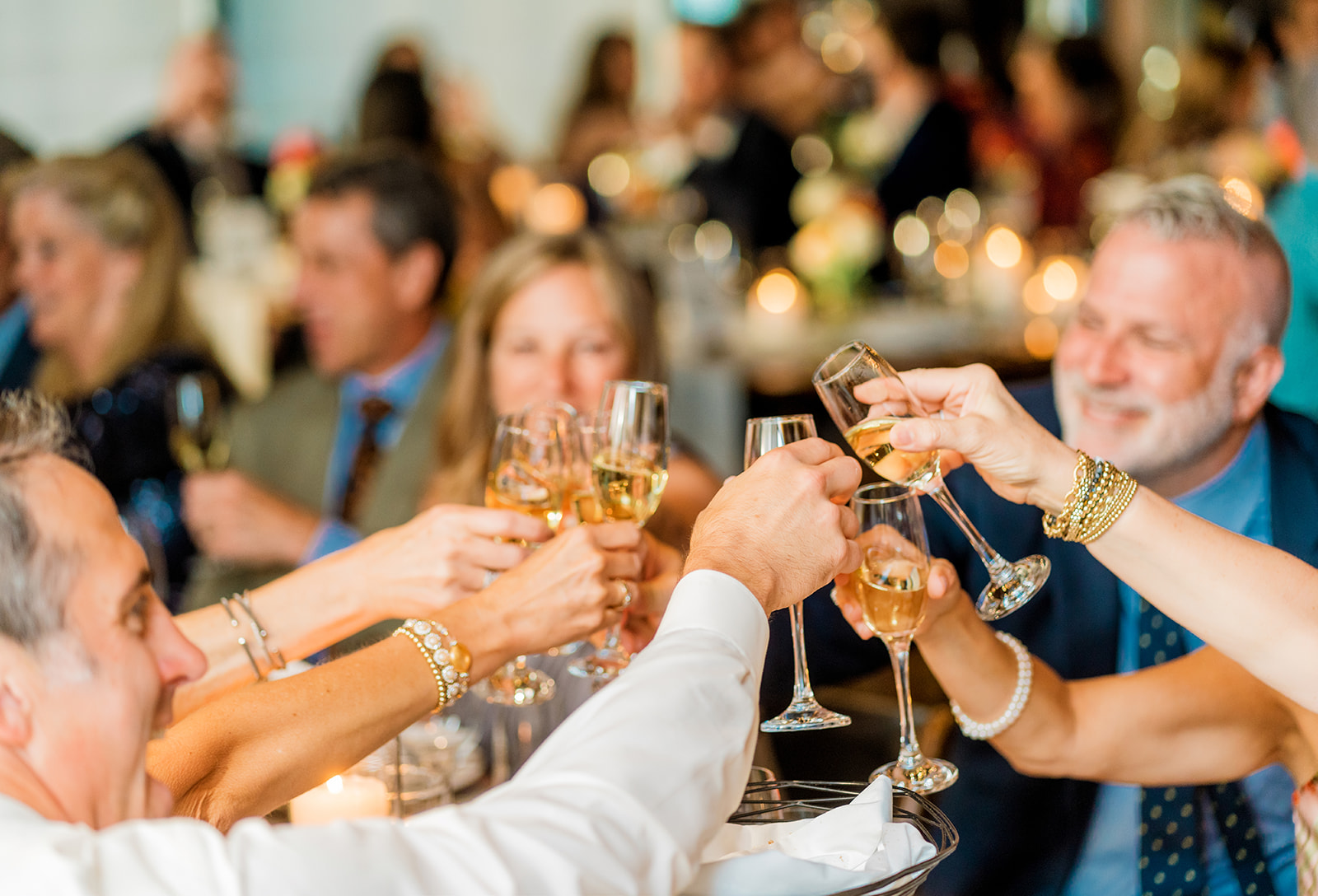 a group of people holding wine glasses