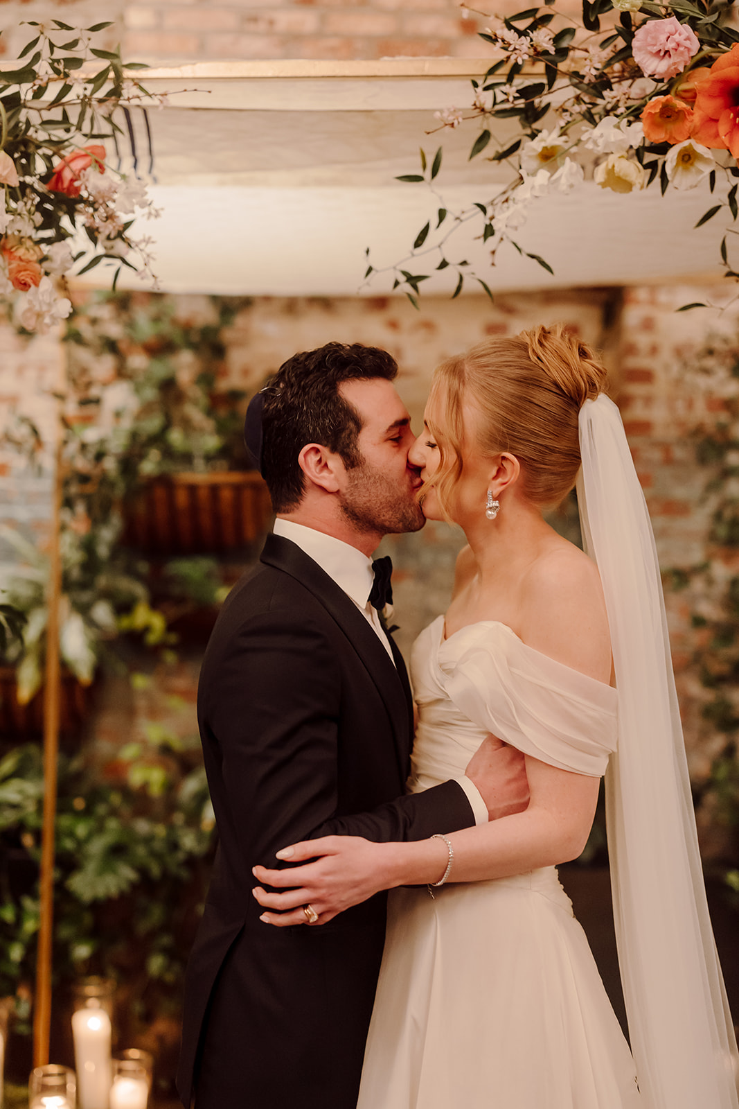 A bride and groom share a first kiss at their wedding at Brooklyn Winery