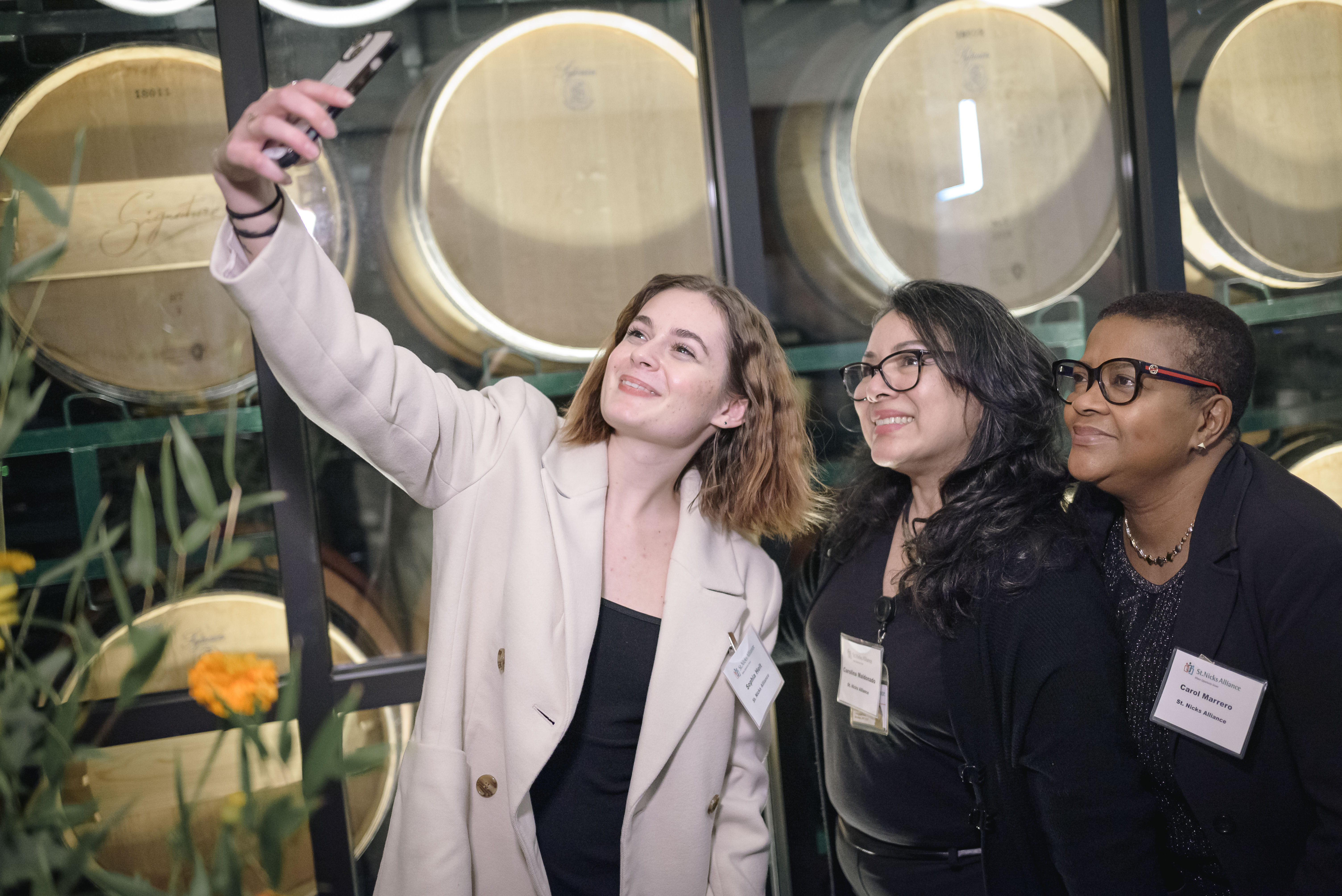 Corporate employees posing at a charity gala event venue that has Expertise in private event planning from black tie events to casual cocktail hours.