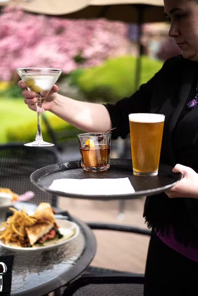 a person sitting at a table with a cup of coffee