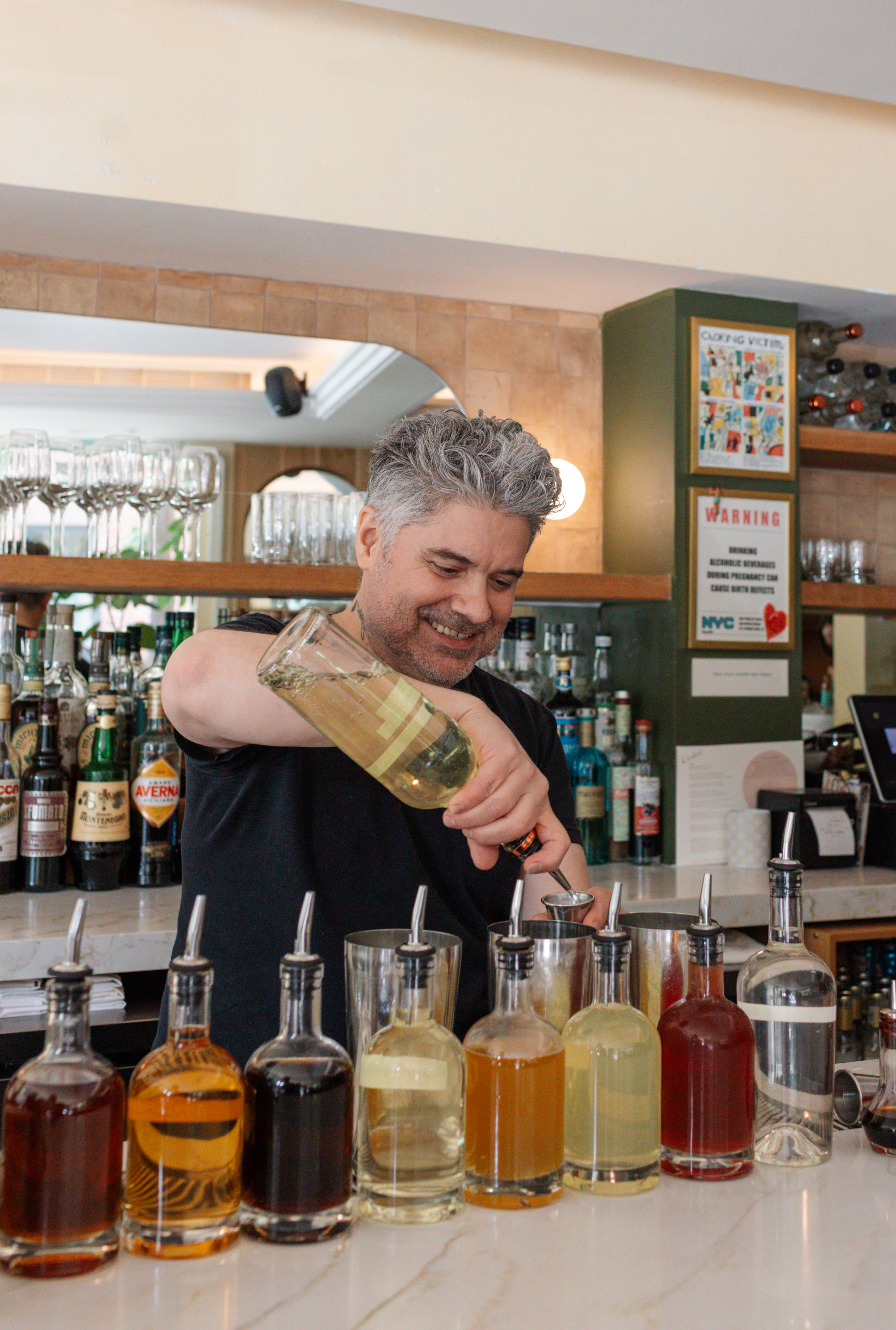 a man pouring a drink into a glass