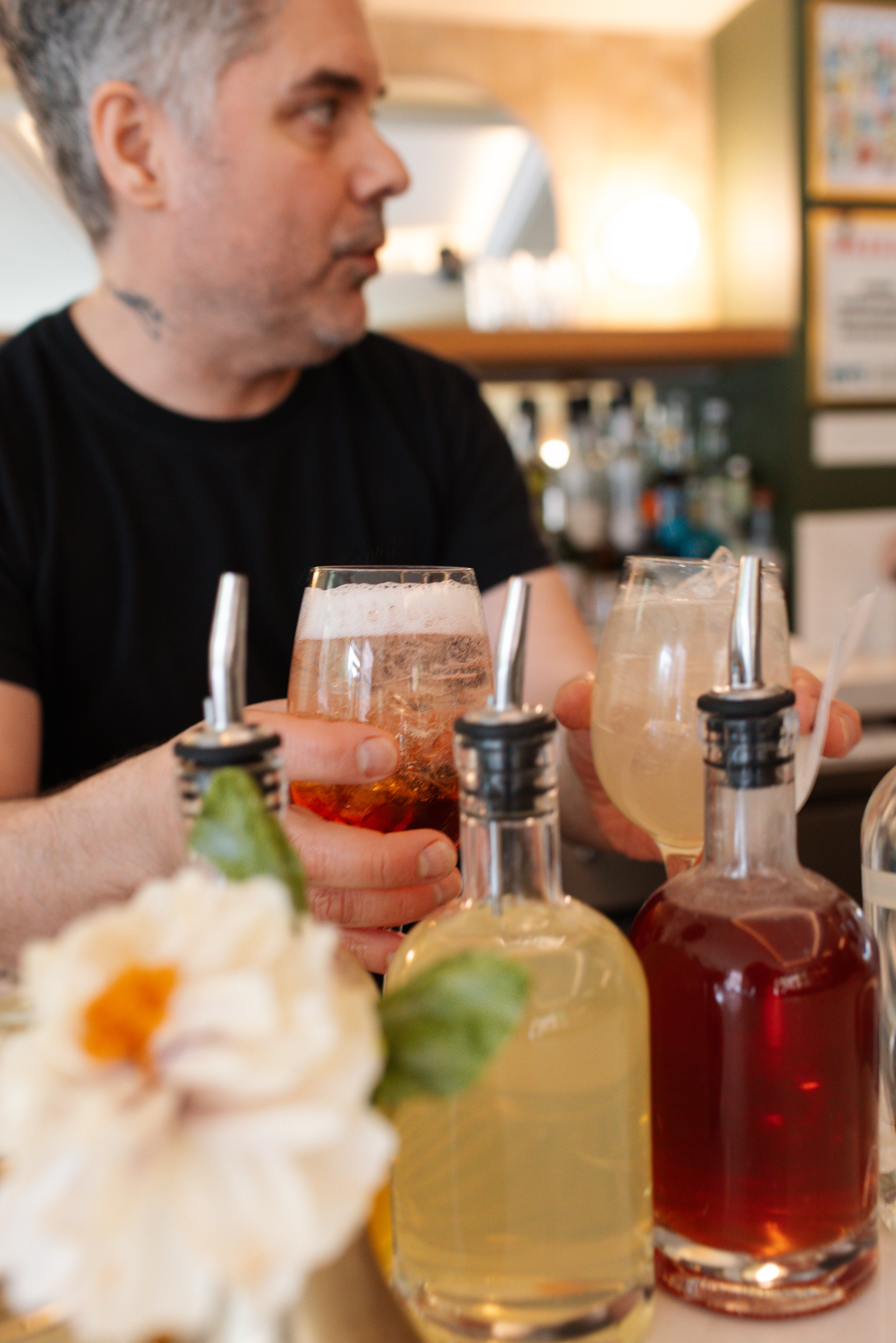a man holding a glass of liquid