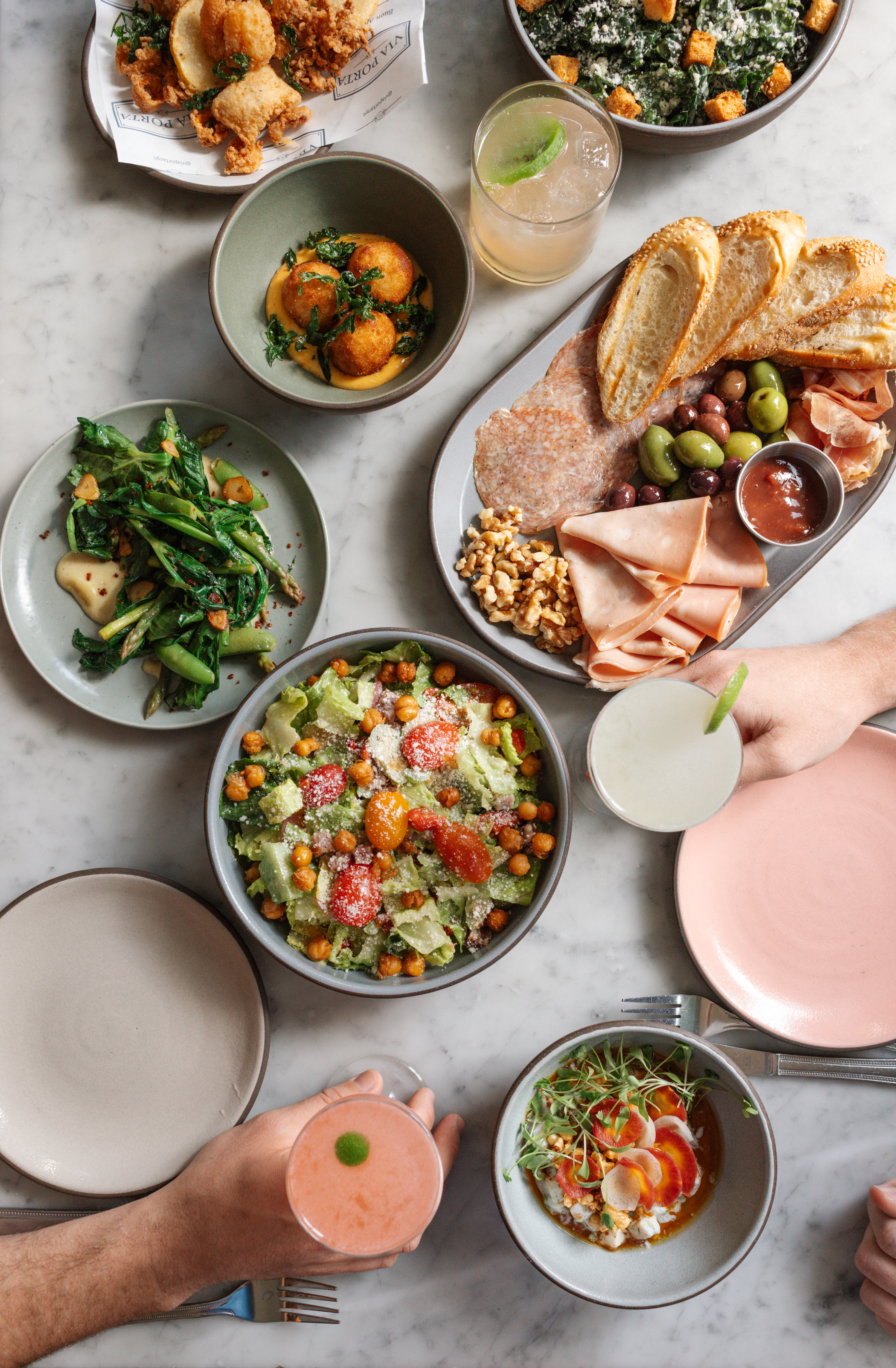 a table with plates of food and drinks