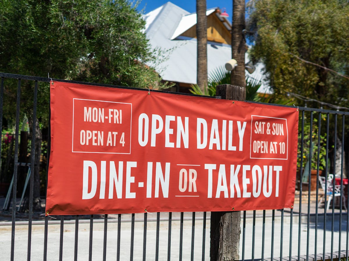 a red sign on a fence