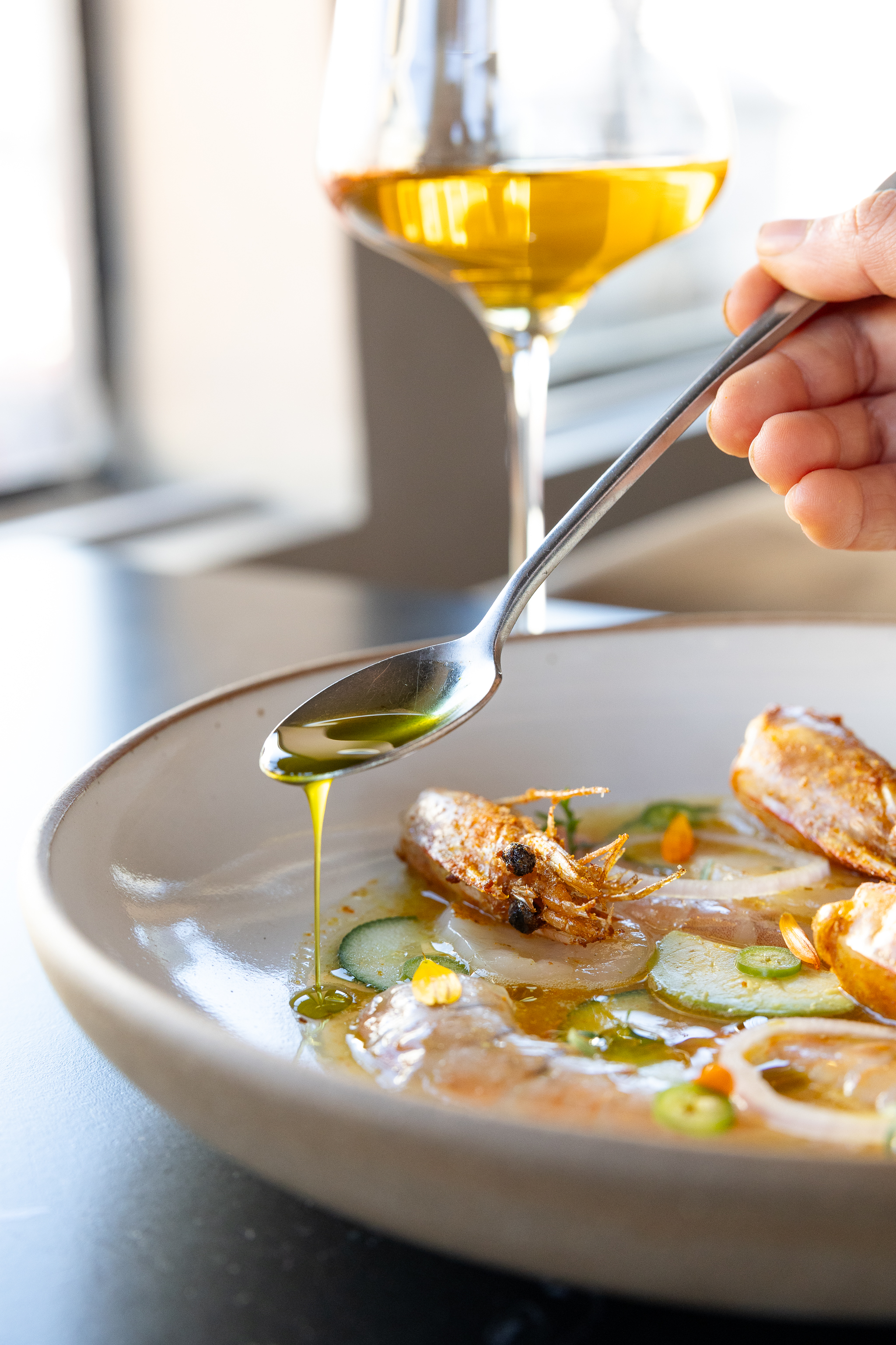a plate of food with a fork and a glass of wine