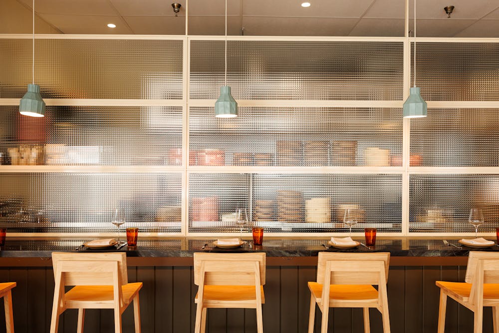 a vase of flowers sits in front of a window