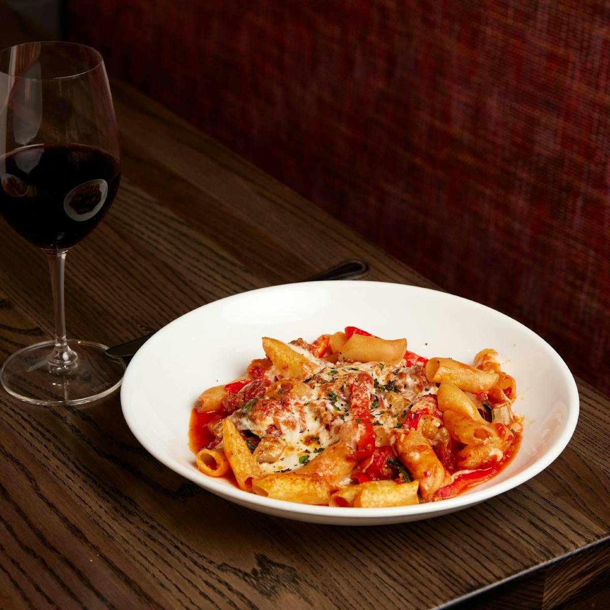 a plate of food and a glass of wine