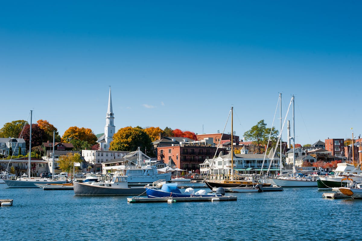 a small boat in a harbor next to a body of water