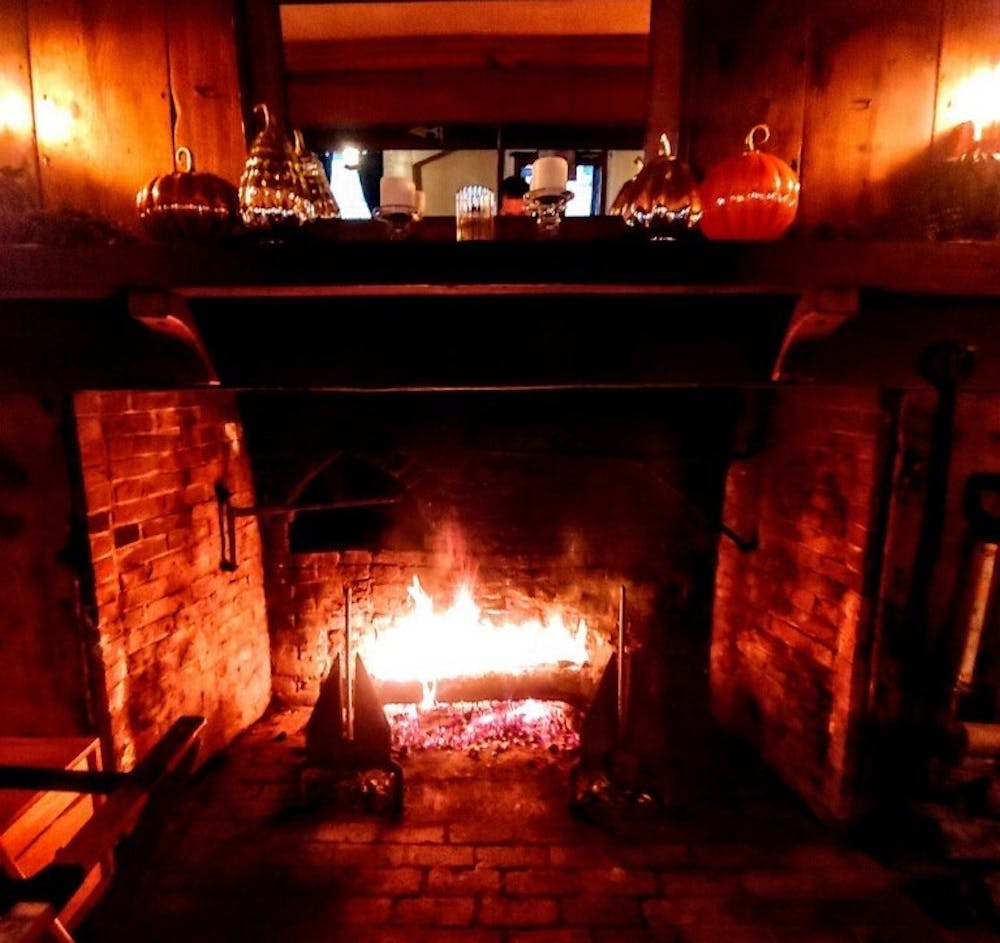 a fire place sitting in a dark room