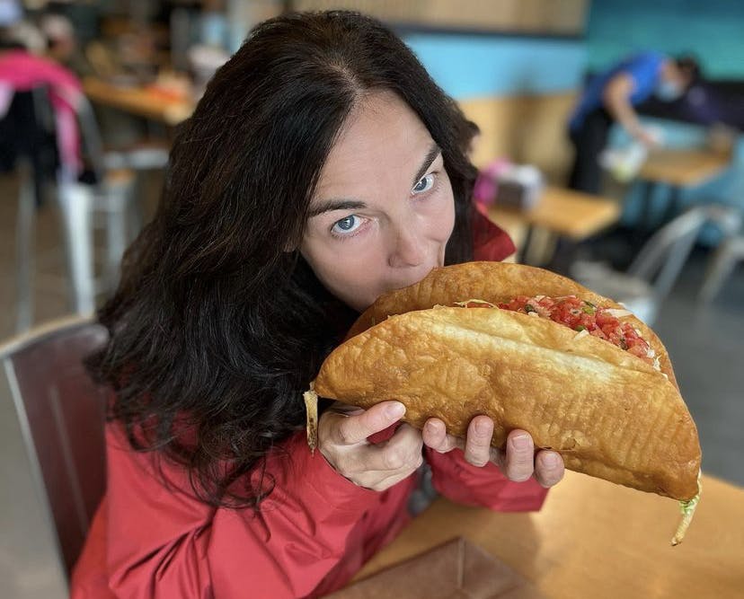 a close up of a person eating a sandwich