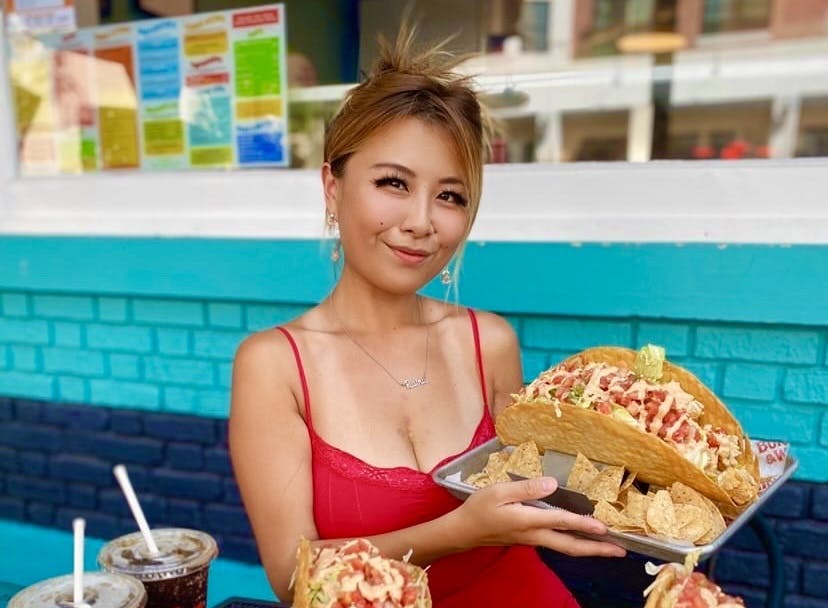 a woman standing in front of a cake