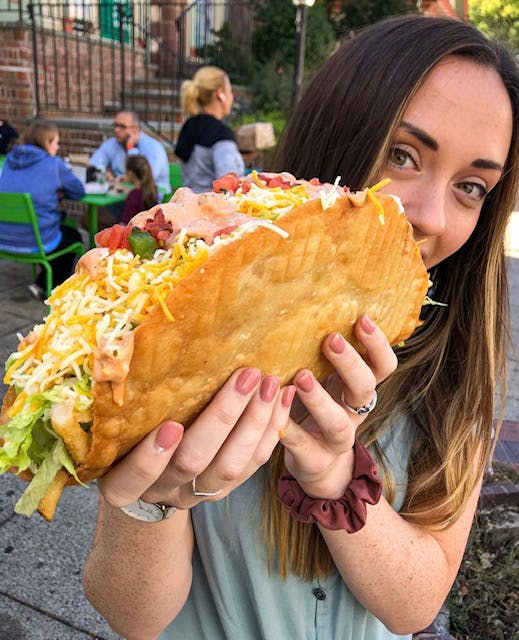 a woman holding a hot dog