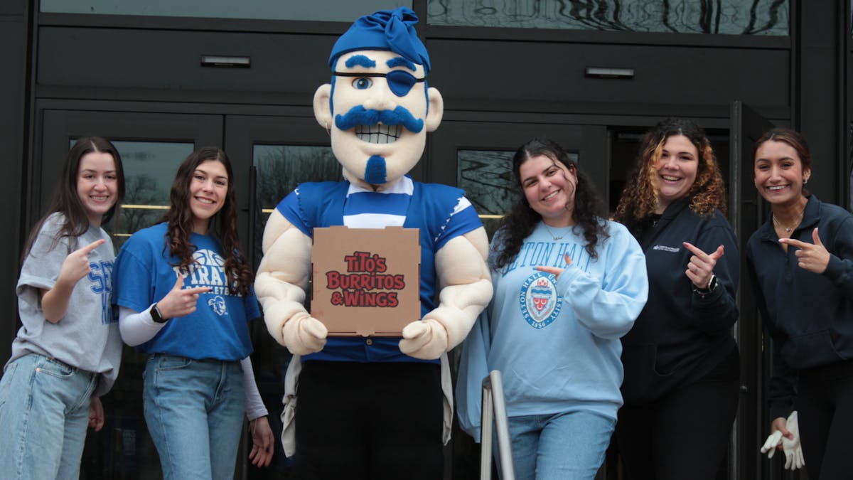 Seton Hall University Pirate and student with Tito's Burritos & Wings quesadilla box