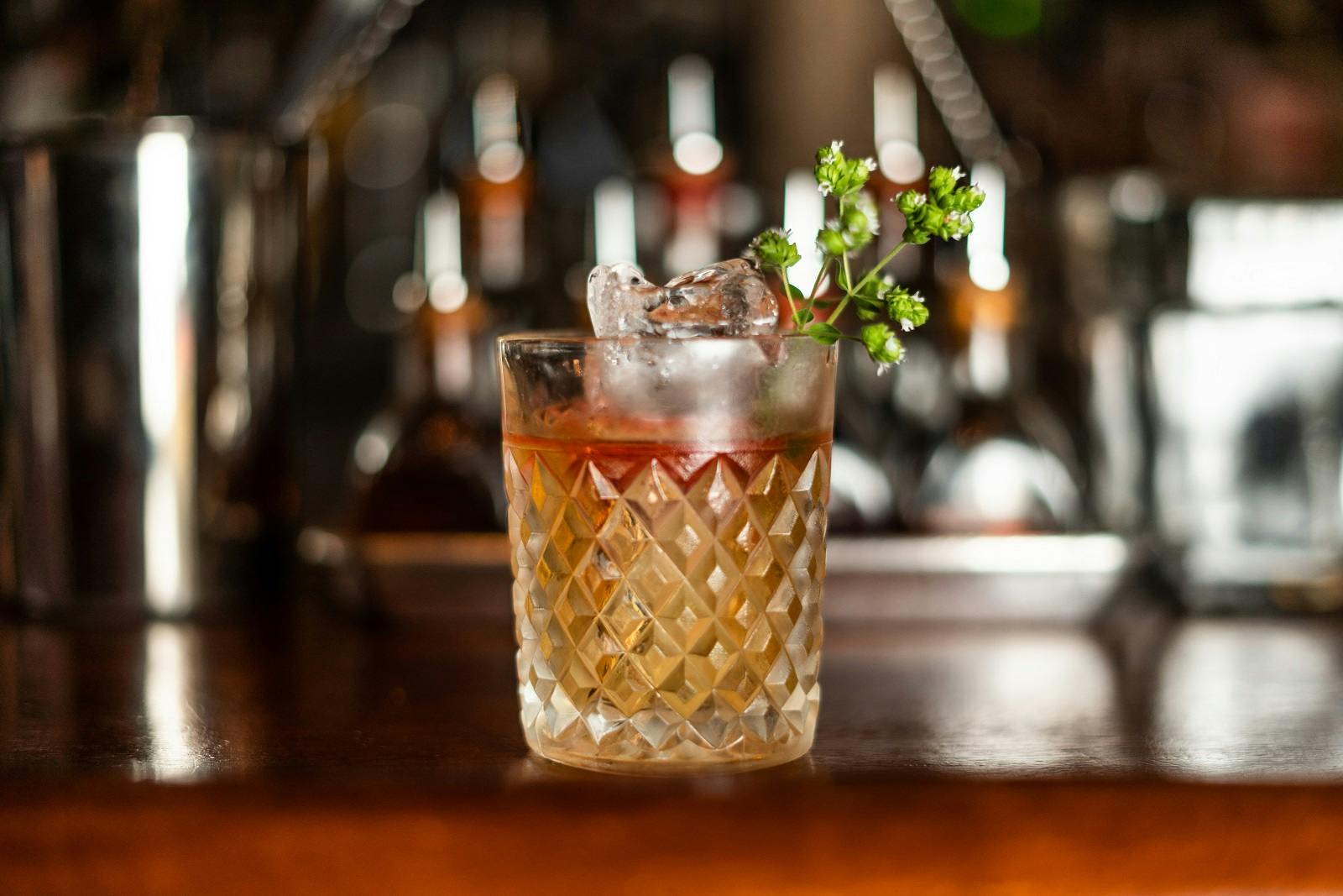 a close up of a cocktail sitting on top of a wooden table