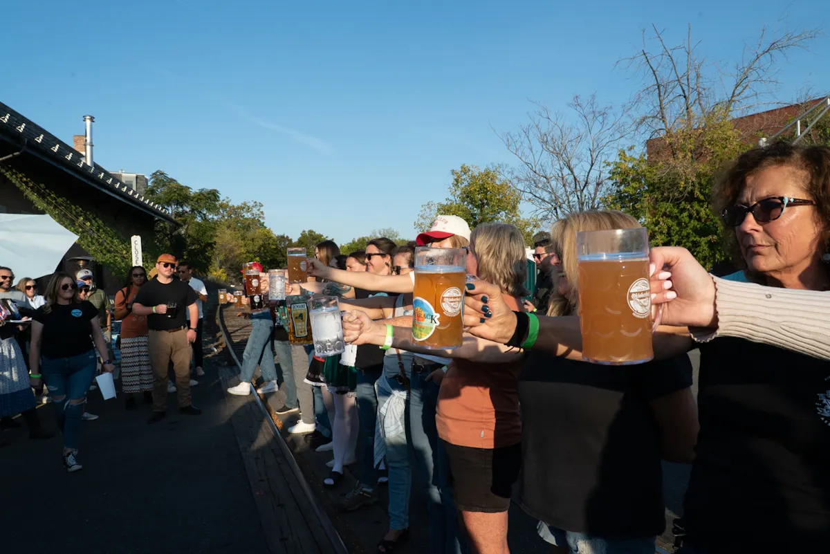Guests raising beer steins together at Hudson Oktoberfest