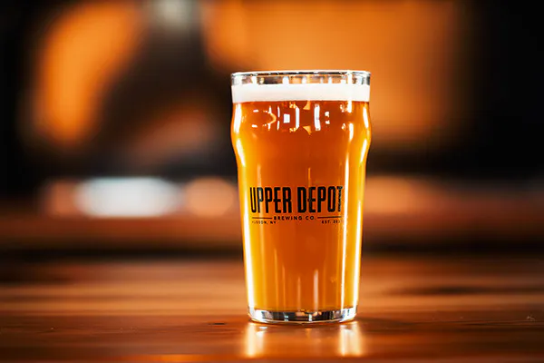 a hand holding a glass of wine