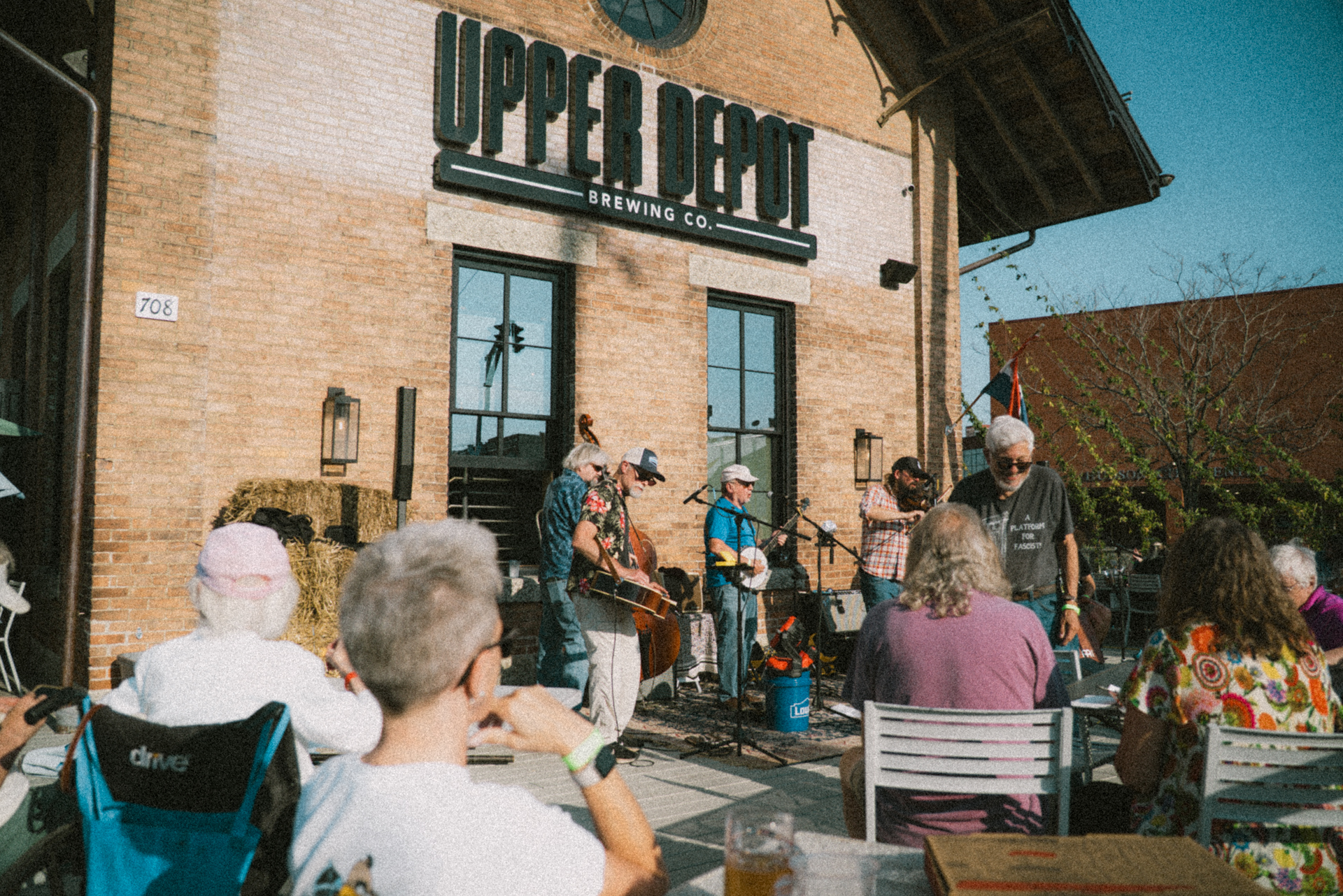 a group of people playing instruments outside of a building