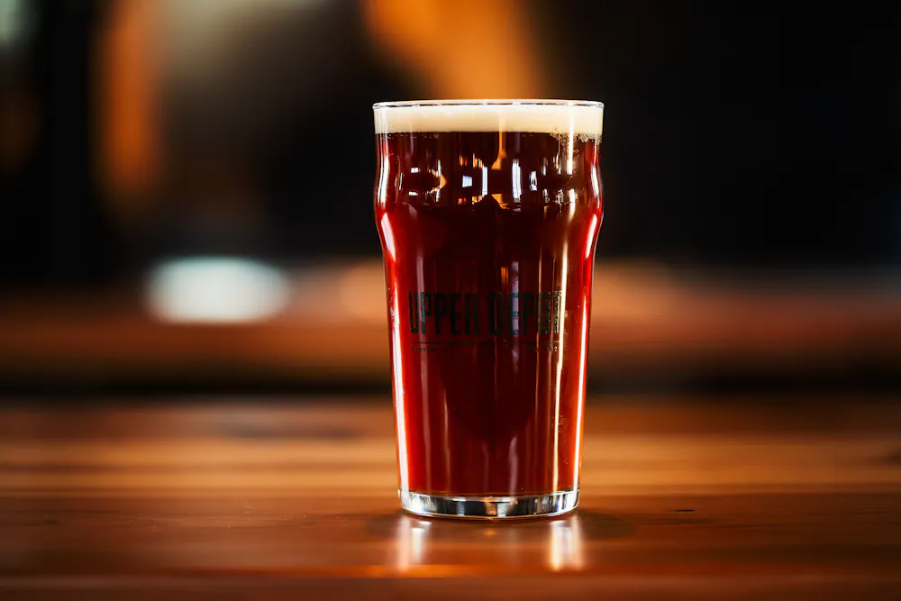 a hand holding a glass of wine