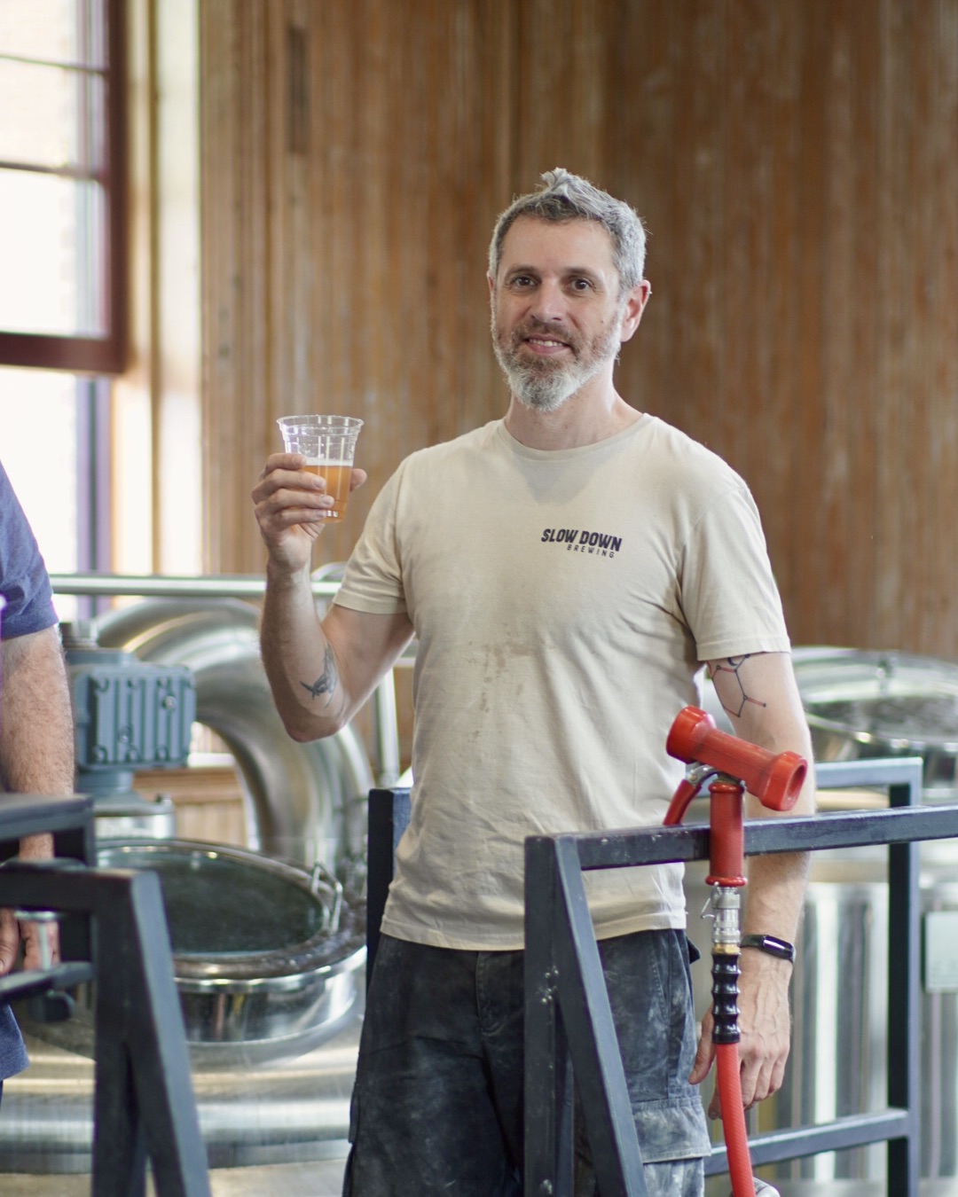 a man holding a glass of liquid