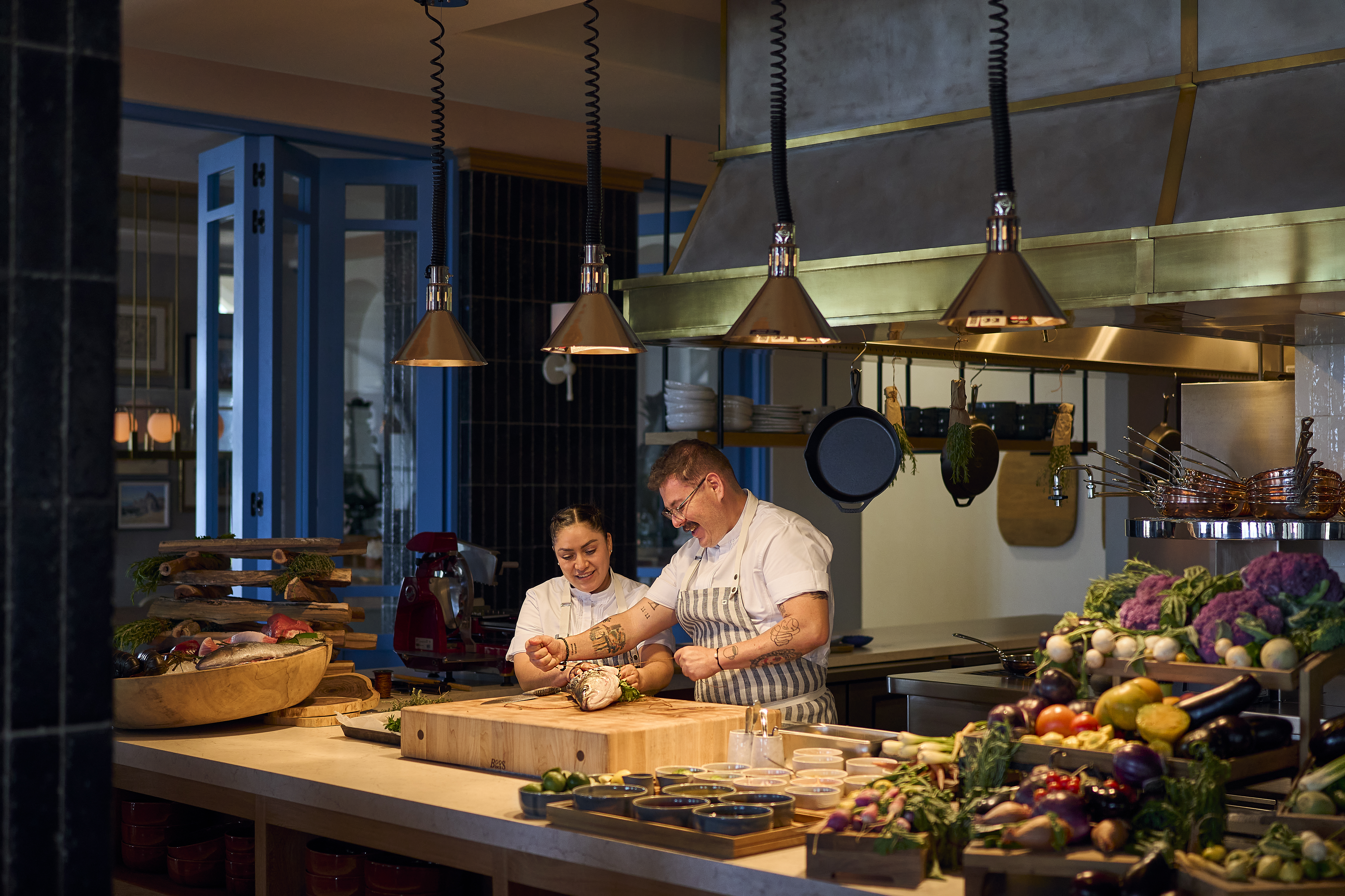 two chefs cooking in the restaurant’s open kitchen