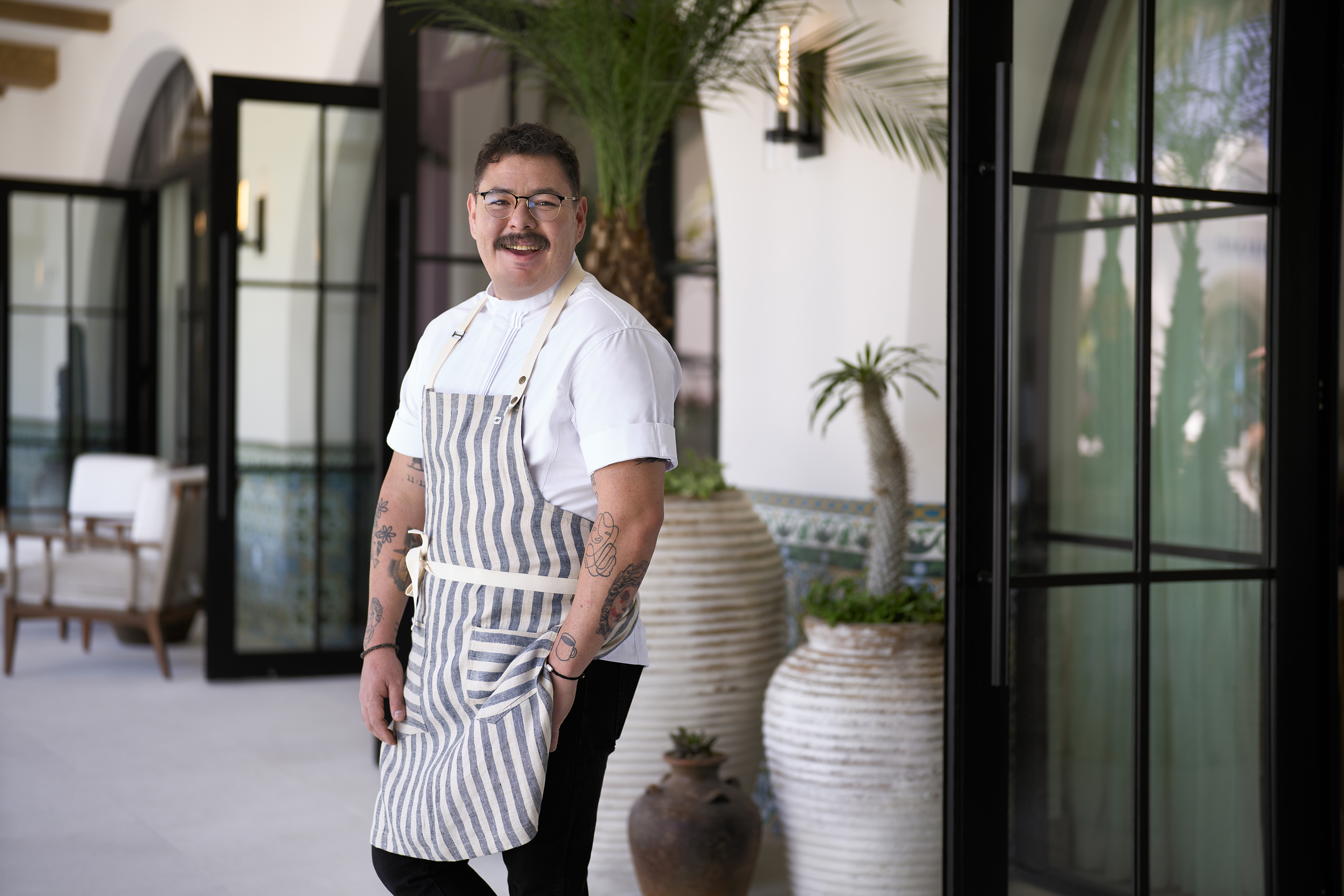a chef posing and smiling