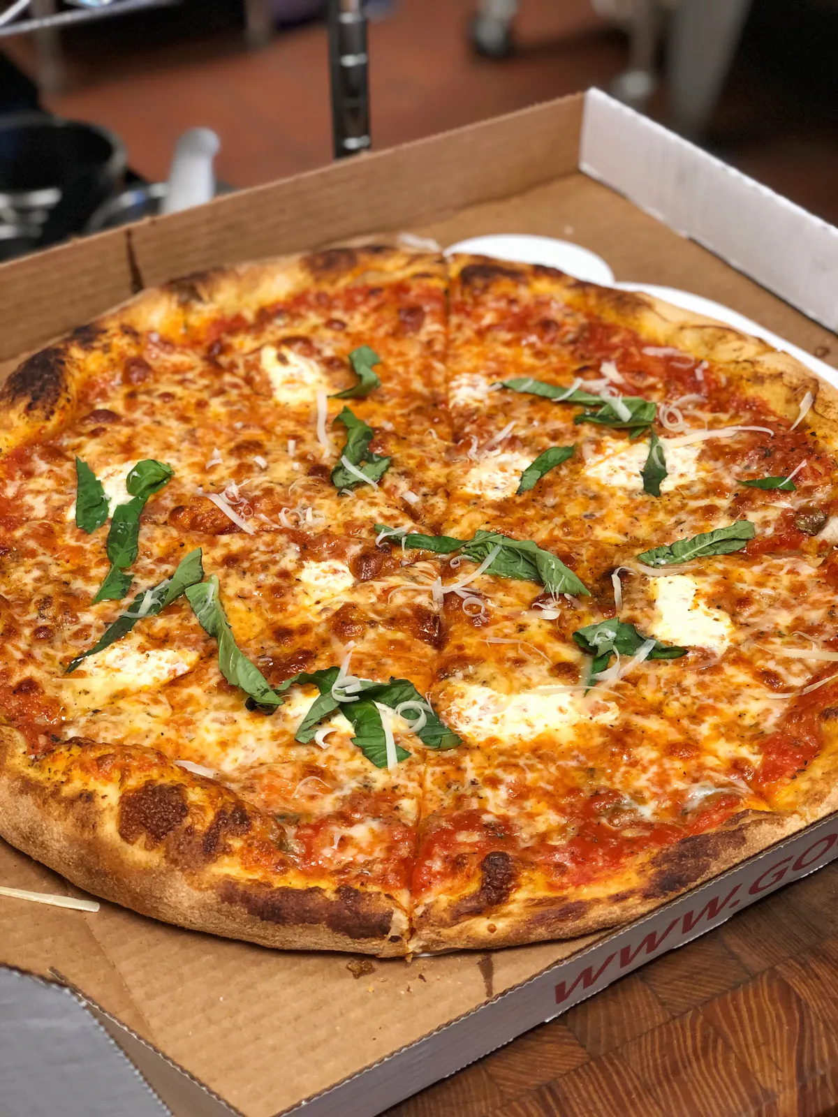 a pizza sitting on top of a wooden cutting board