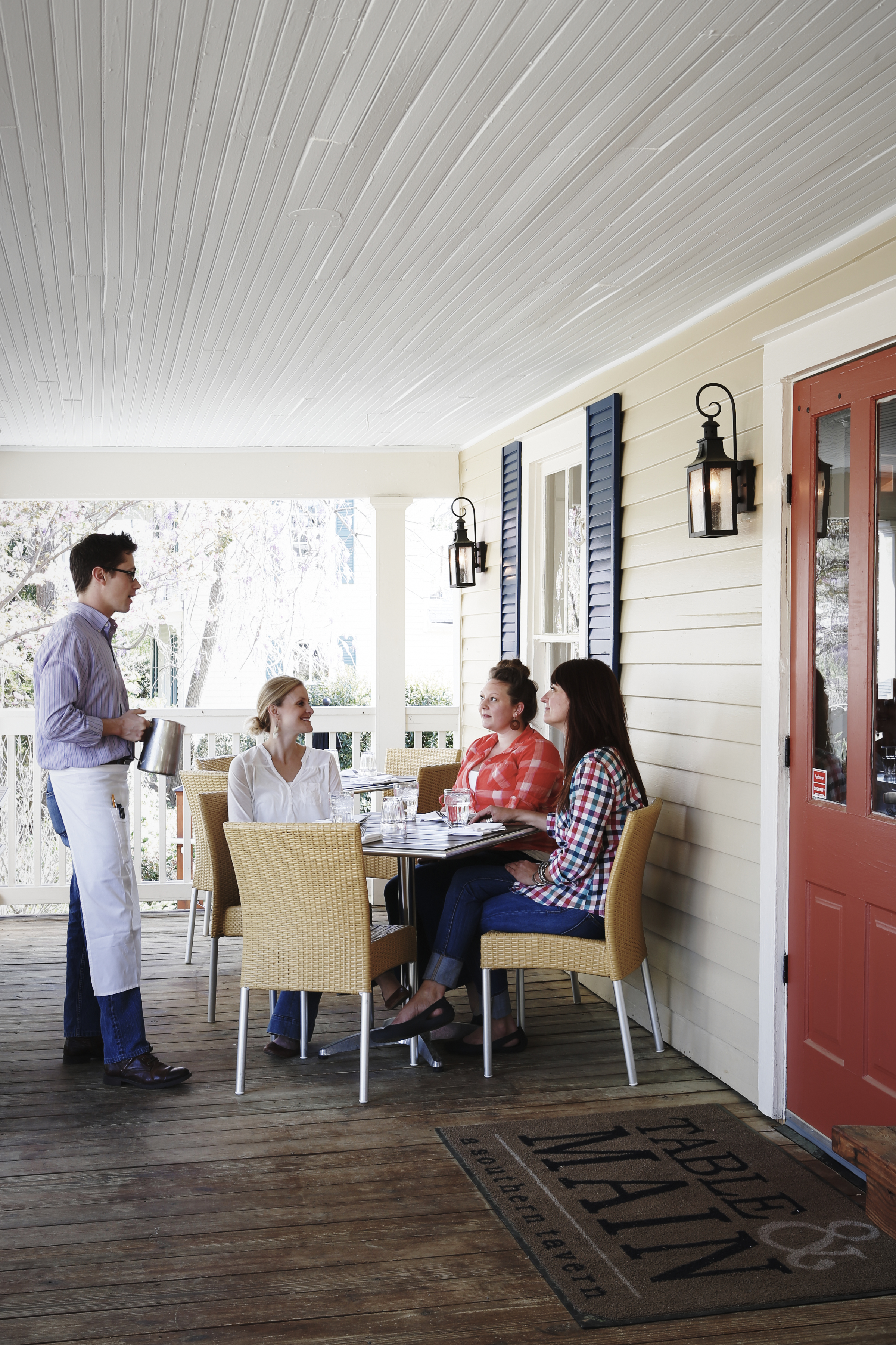 A group of people at Table & Main's front porch.