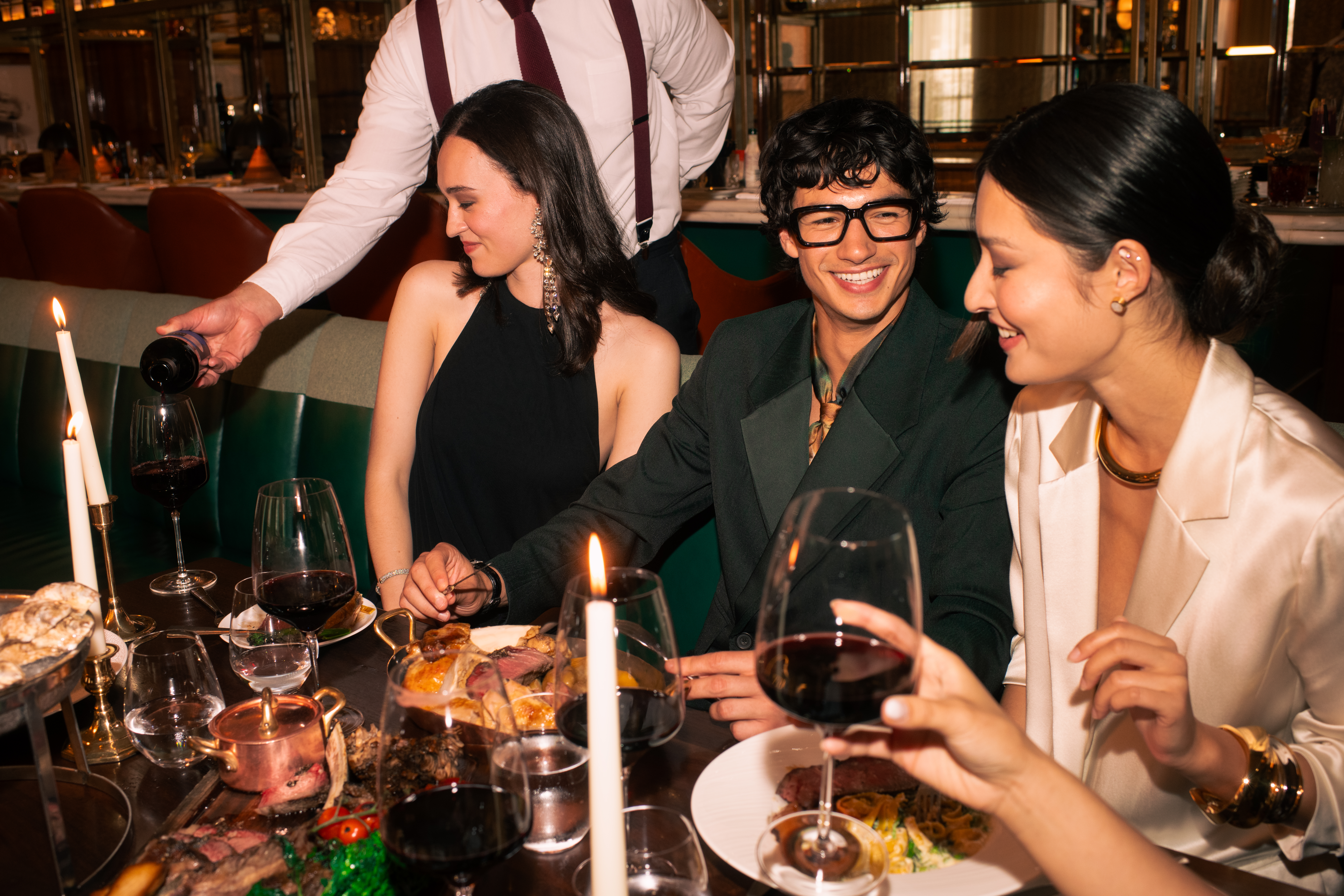 a group of people sitting at a table with wine glasses