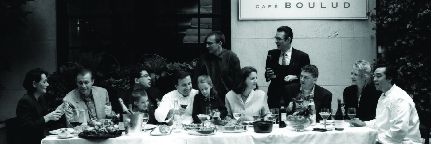 a group of people sitting at a table in a restaurant