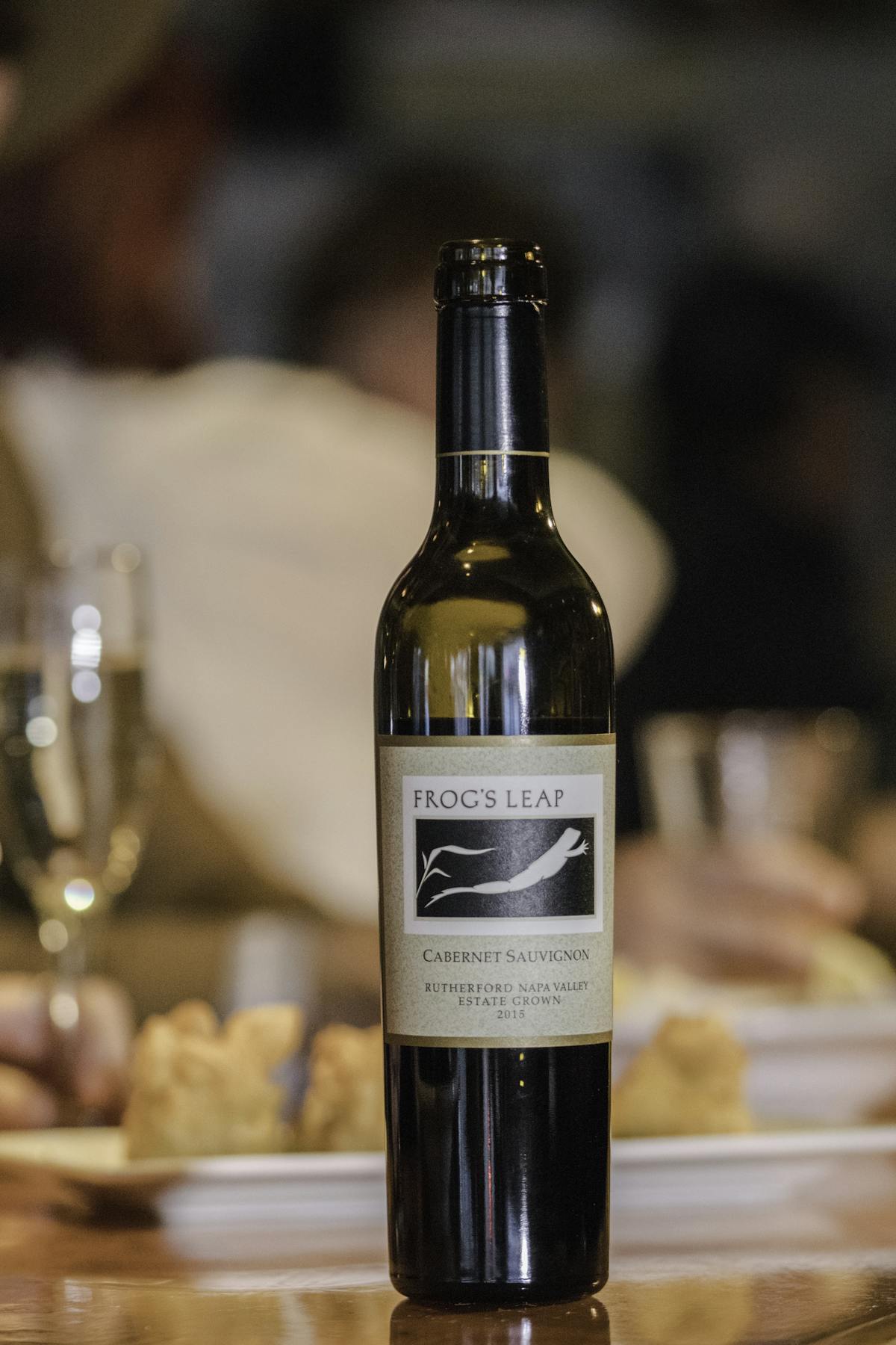 a close up of a bottle and a glass of wine