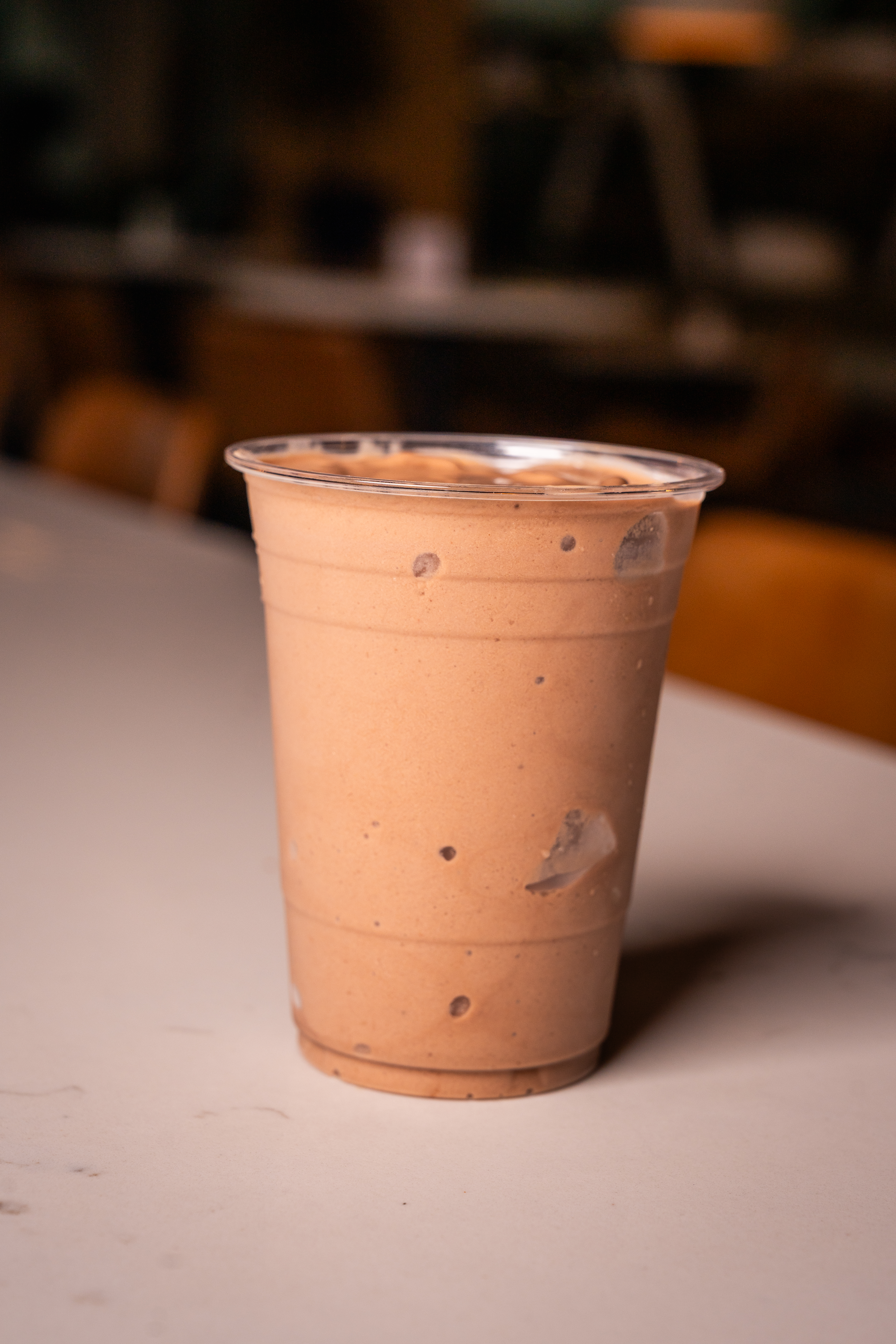 a plastic cup with a brown liquid in it