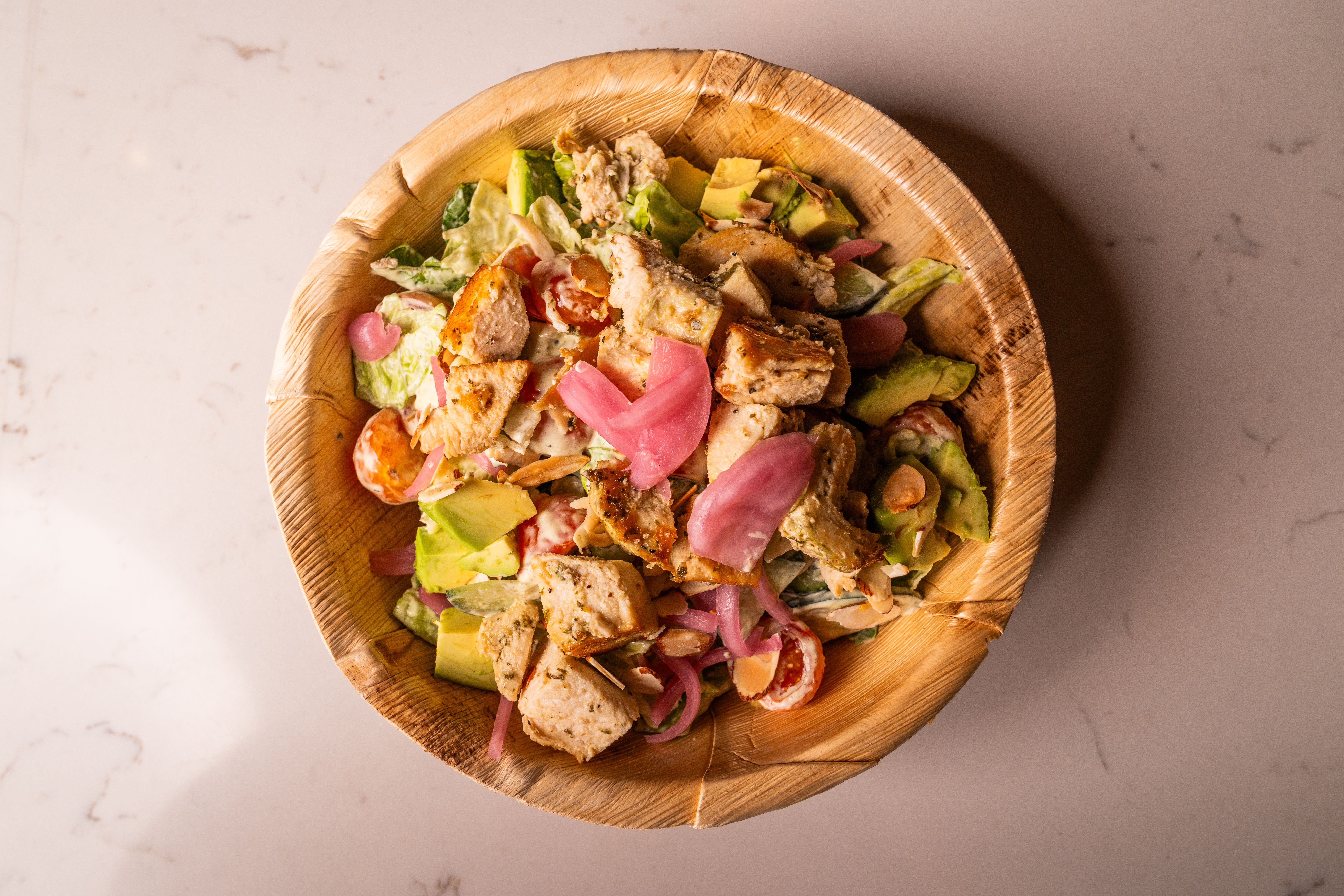 a bowl of salad with meat and vegetables