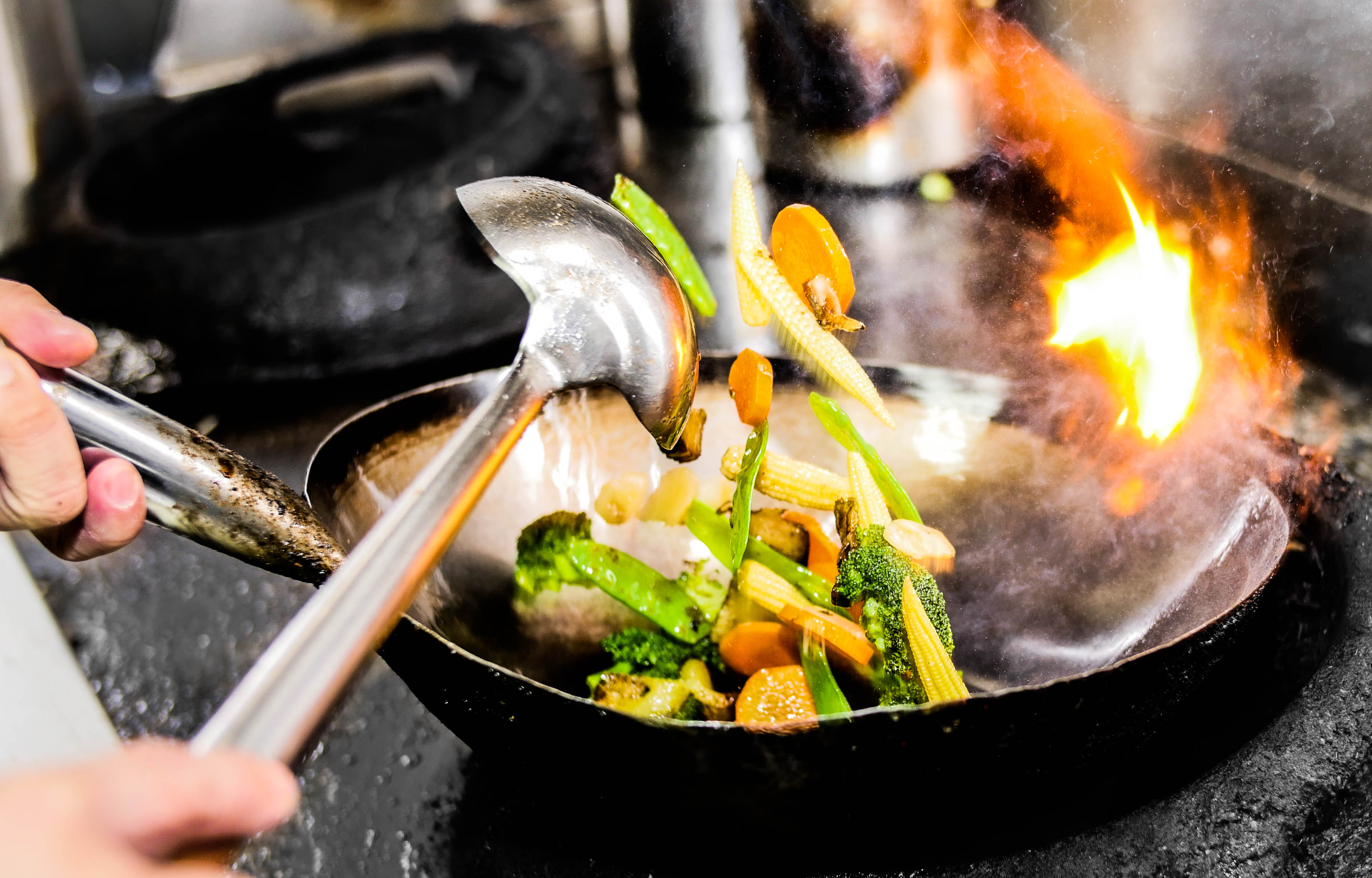 a person cooking food on a stove