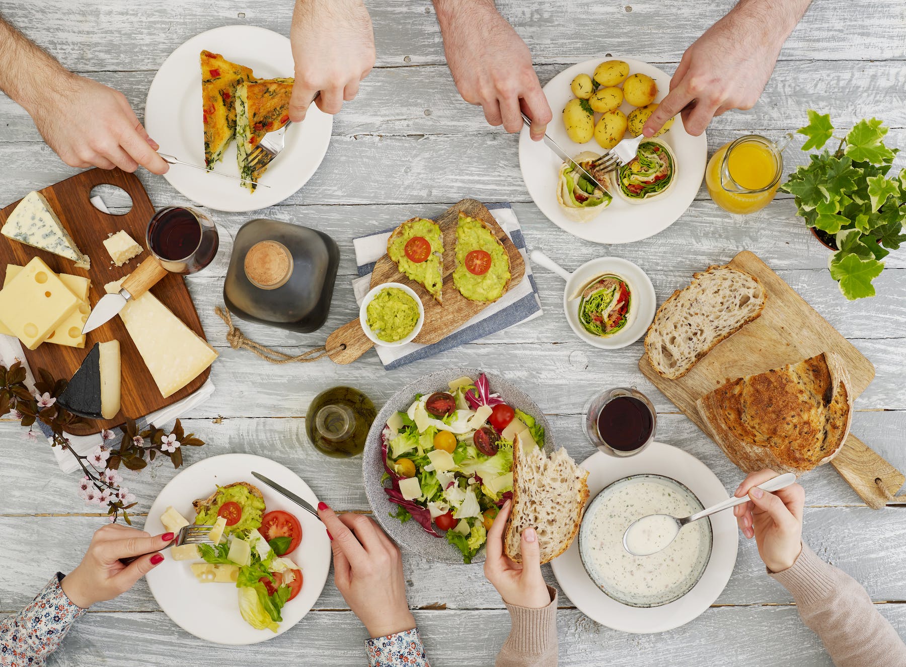 a man holding a plate of food on a table